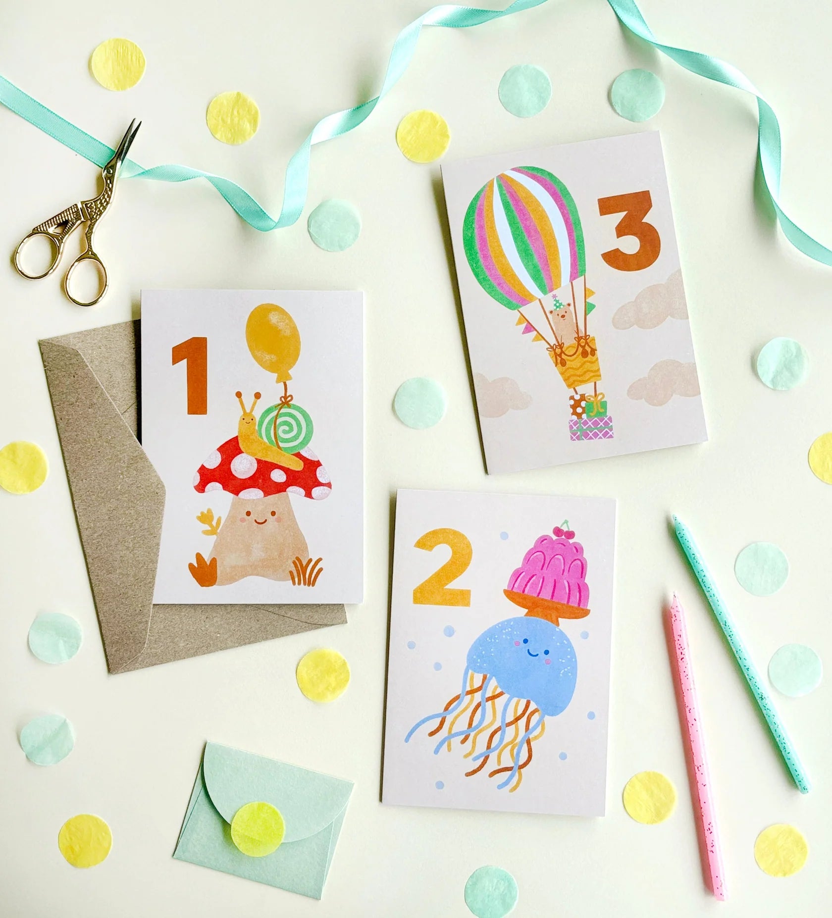 A 1st, 2nd and 3rd birthday milestone cards with illustrations of snails, hot air balloons and jellyfish on them.