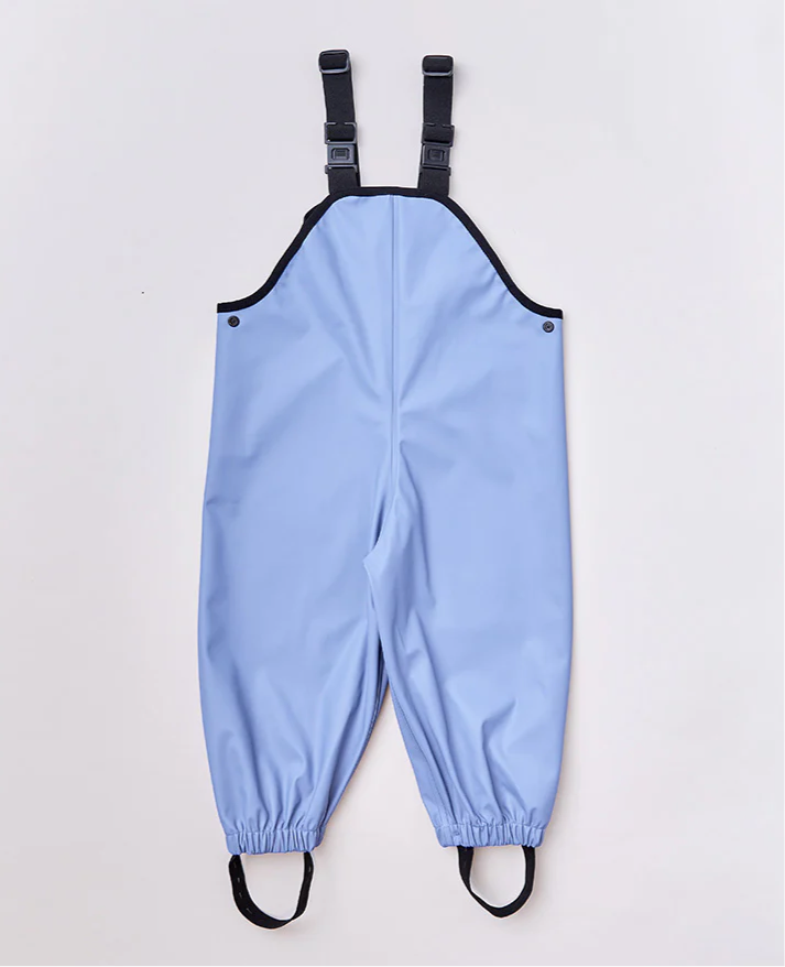 The RAINKOAT Rainkoat Waterproof Overalls in Storm Blue feature adjustable black straps and elasticized ankles, ideal for rainy play dates. Designed for wet conditions with a smooth finish and minimal detailing against a plain white background.