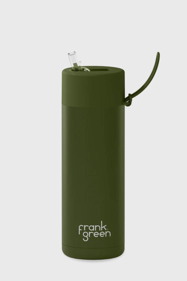 Introducing the Frank Green Ceramic Reusable Bottle, featuring a khaki color and a 595ml (20oz) capacity. This vacuum insulated bottle has a cylindrical shape, complete with a convenient flip-up straw and a handle attached to the lid. The bottom of the bottle is prominently labeled with "FRANK GREEN" in white letters against its plain white background.