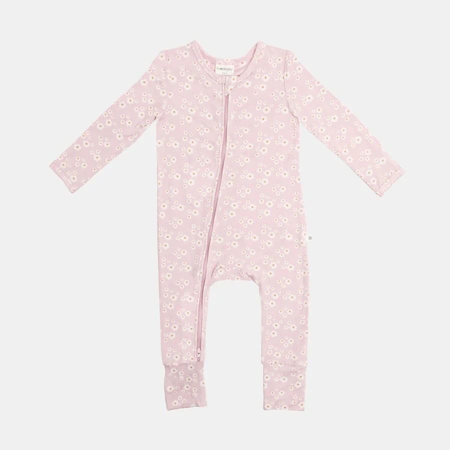 The Day or Night Onesie Orchid Bloom by KYND BABY features long sleeves and a convenient front zipper for easy changes, with a pink design embellished with small white flowers on a light gray background. Made from EcoCosy Viscose, it combines comfort and sustainability for your baby.