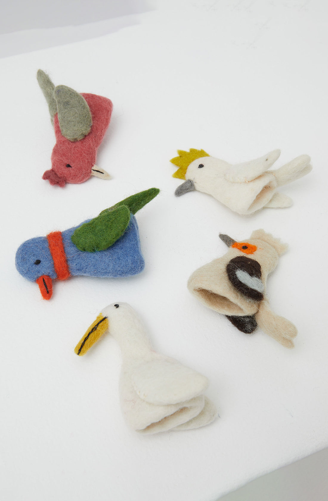 Australian bird puppets lying on their side.