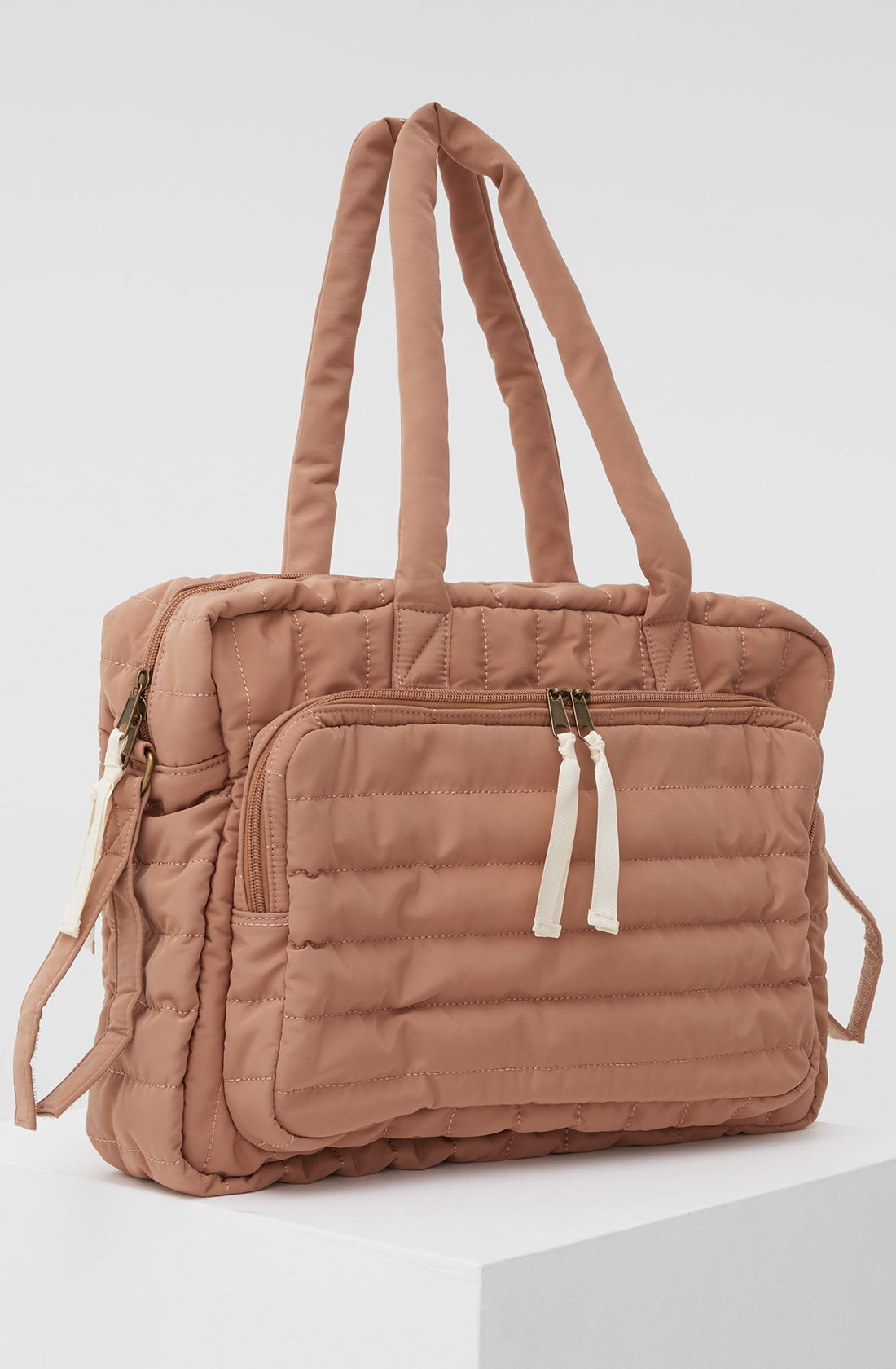 PHILÉ baby bag in terracotta on a 45 degree angle.