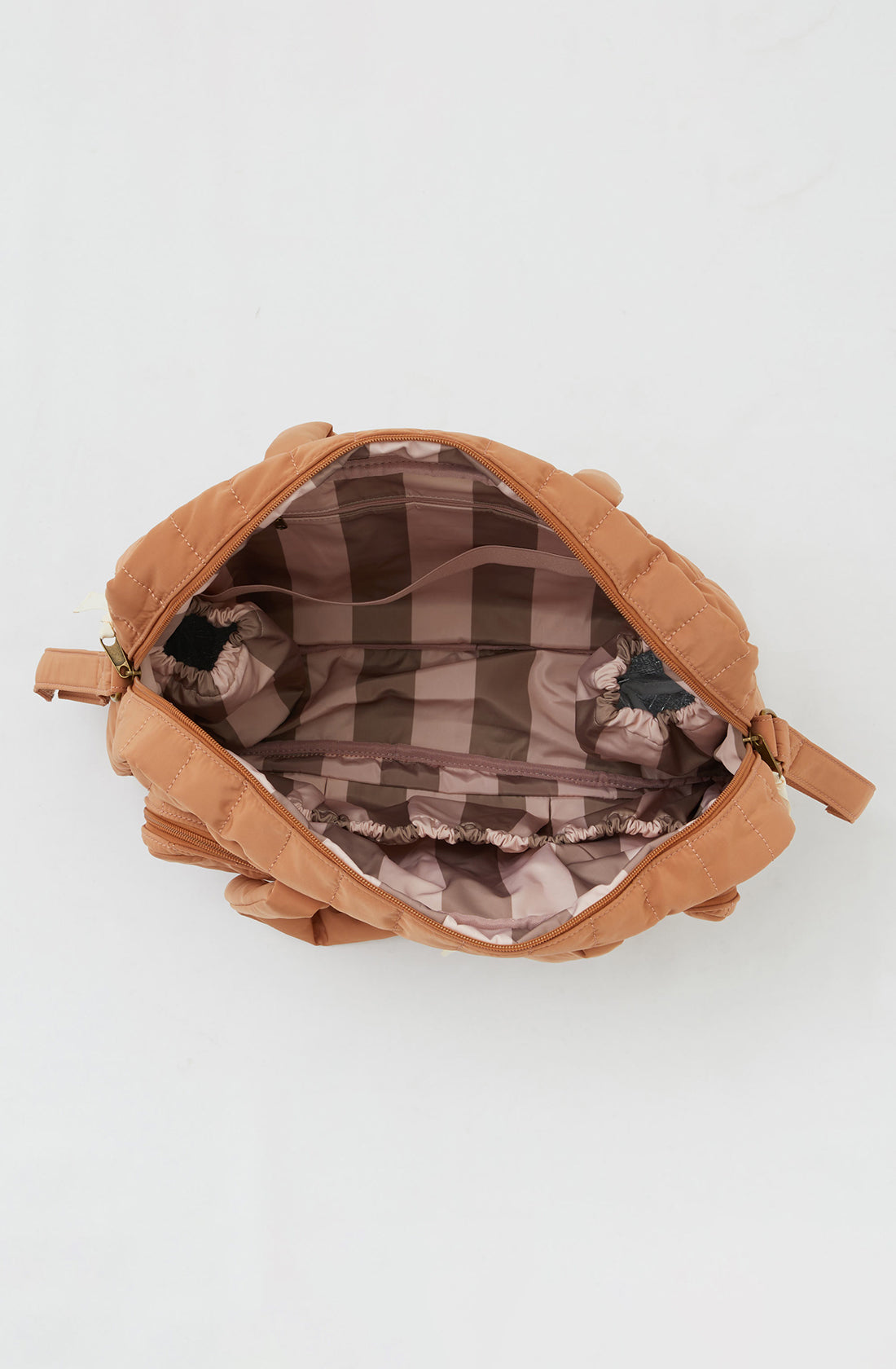 PHILÉ baby bag in terracotta with the zip open showing the inside of the bag.