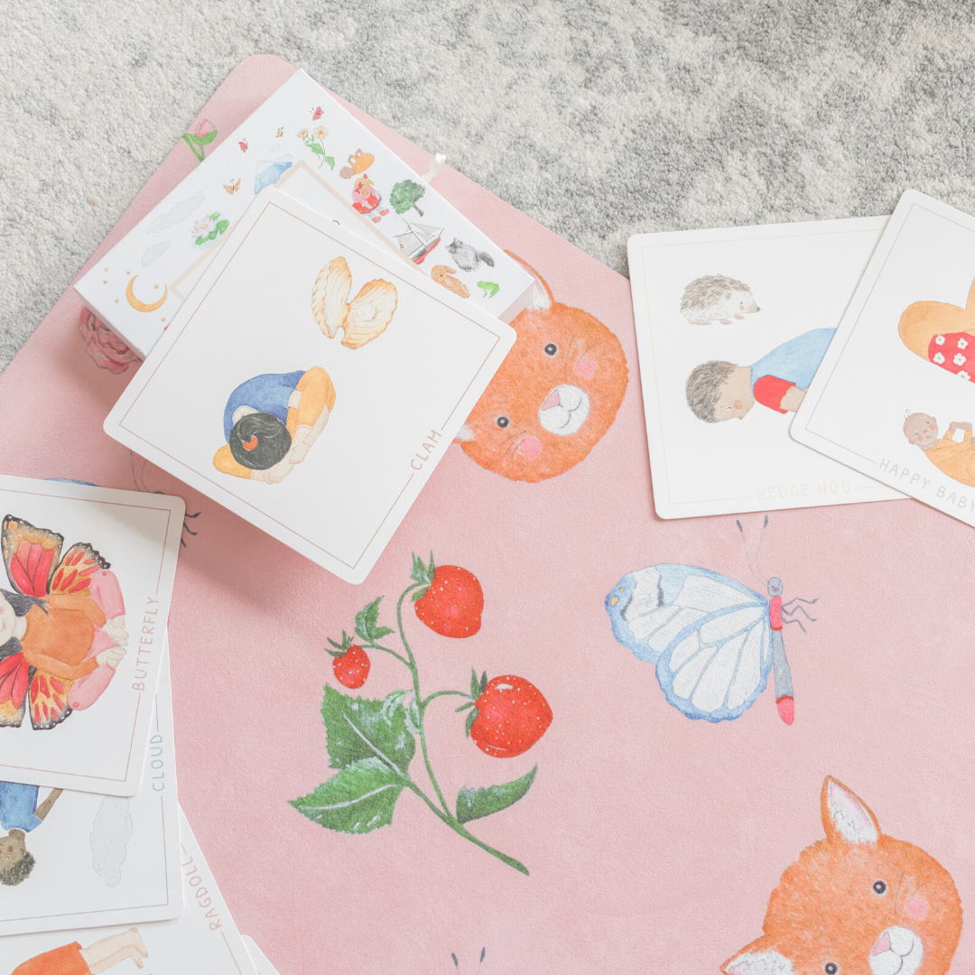 The sweet themed pink kids yoga mat with cards scattered over it.