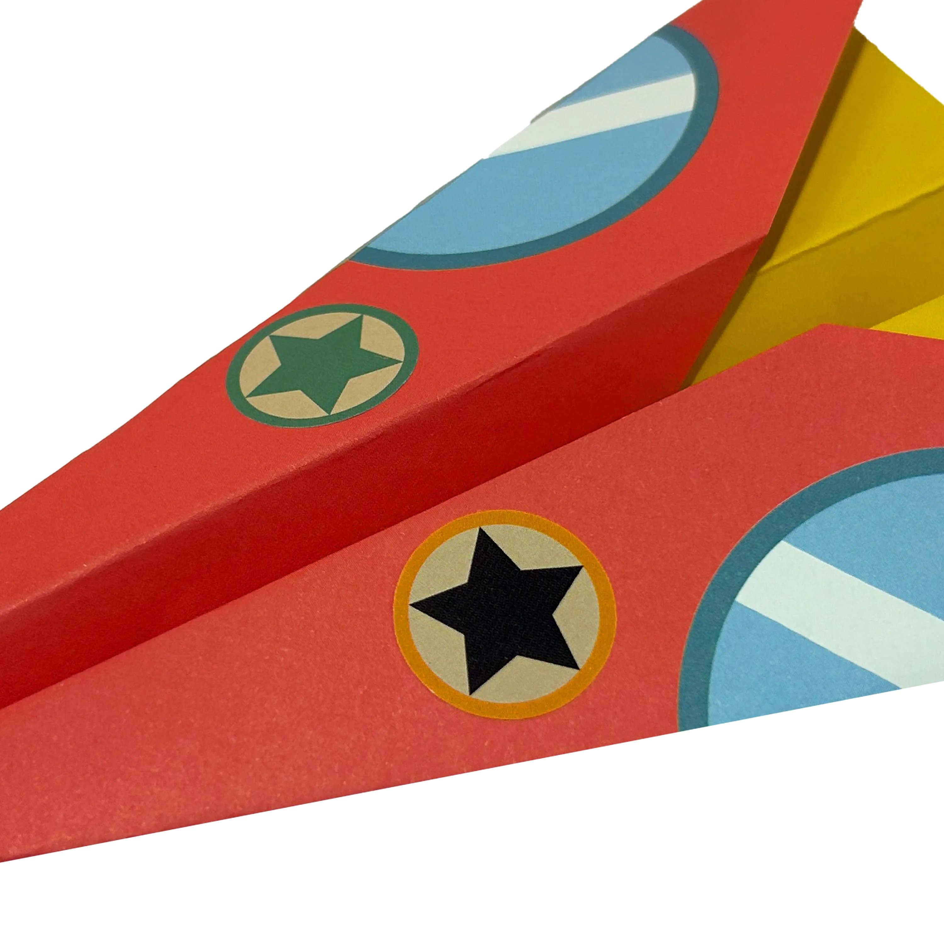 A close up of the OOLY DIY paper airplane.