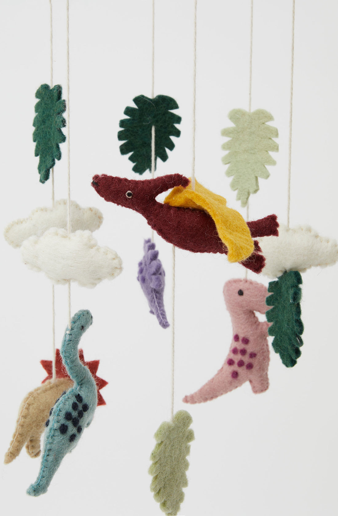 A close up of the PHILÉ baby mobile with hanging dinosaurs.