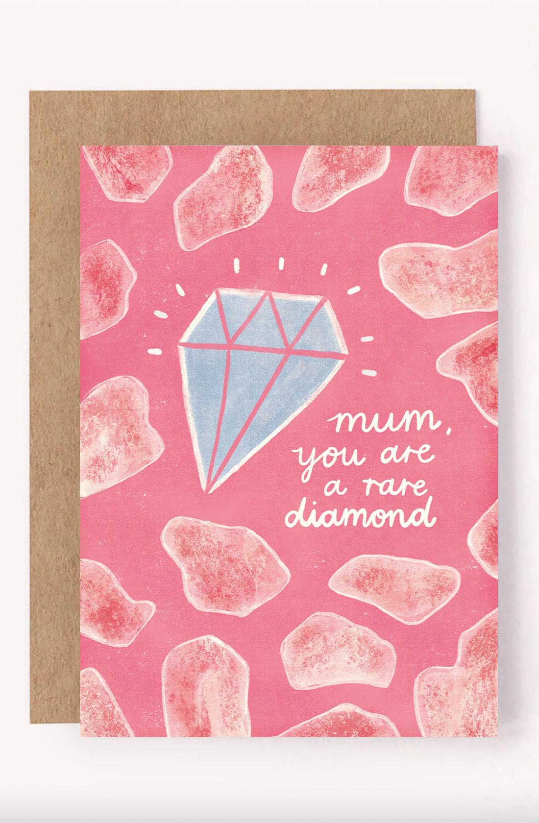 The Mother's Day Greeting Card "Mum, You Are A Rare Diamond" from LAUREN SISSONS STUDIO showcases a large, shiny diamond illustration at its center against a pink background, surrounded by various pink gemstone shapes. The white text on the card reads, "mum, you are a rare diamond." This beautifully illustrated greeting card is accompanied by an eco-friendly brown envelope made from recycled paper.