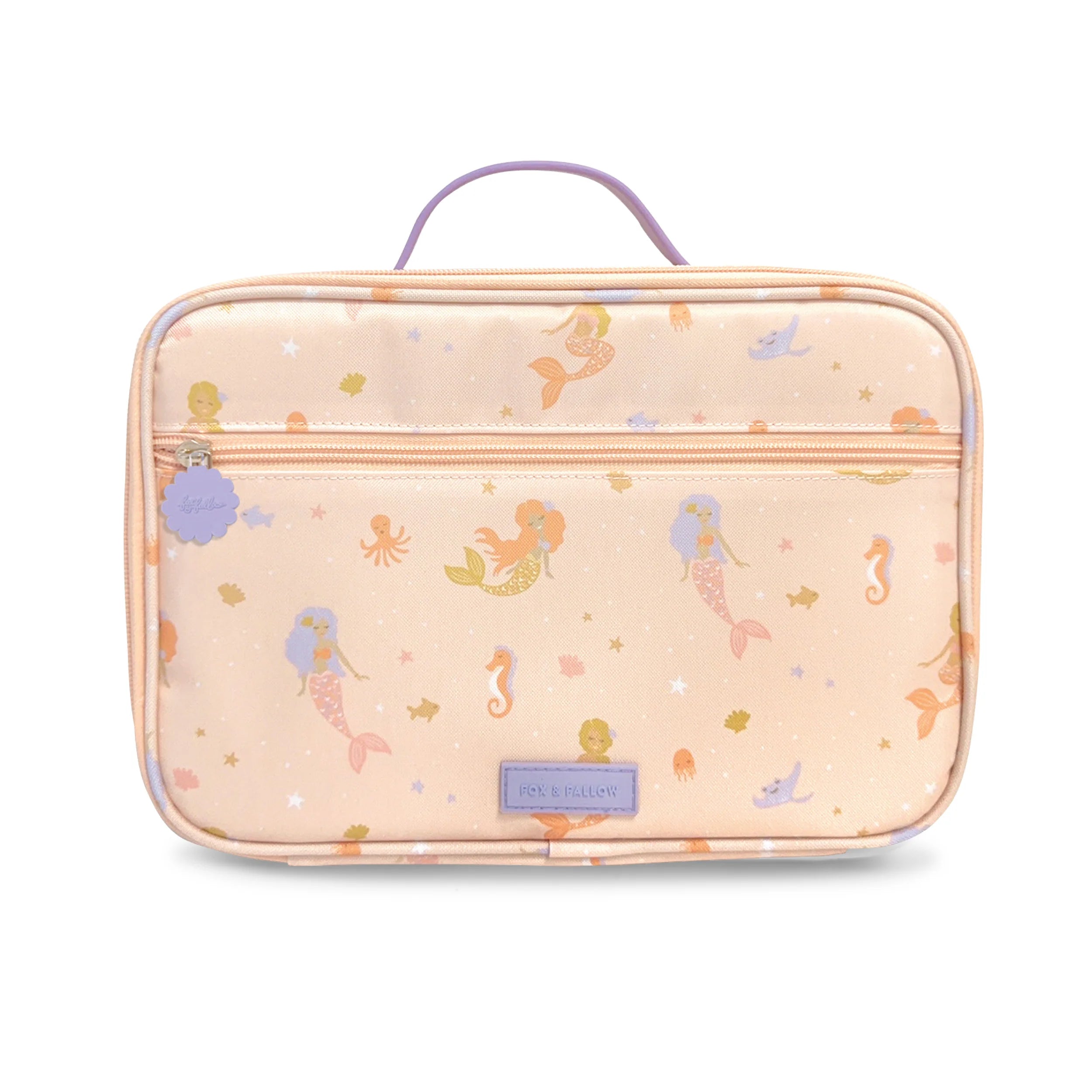 The Mermaids Lunch Bag by FOX & FALLOW is a peach-colored bag with a lavender handle and zipper, adorned with a whimsical mermaid pattern made from waterproof fabric. It features illustrations of mermaids, sea horses, seashells, and starfish in pastel colors and includes a small purple tag attached to the zipper pull.