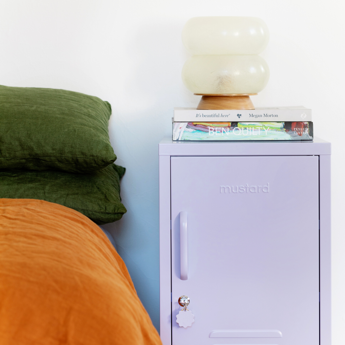 The shorty (to the right) locker in lilac next to bed.