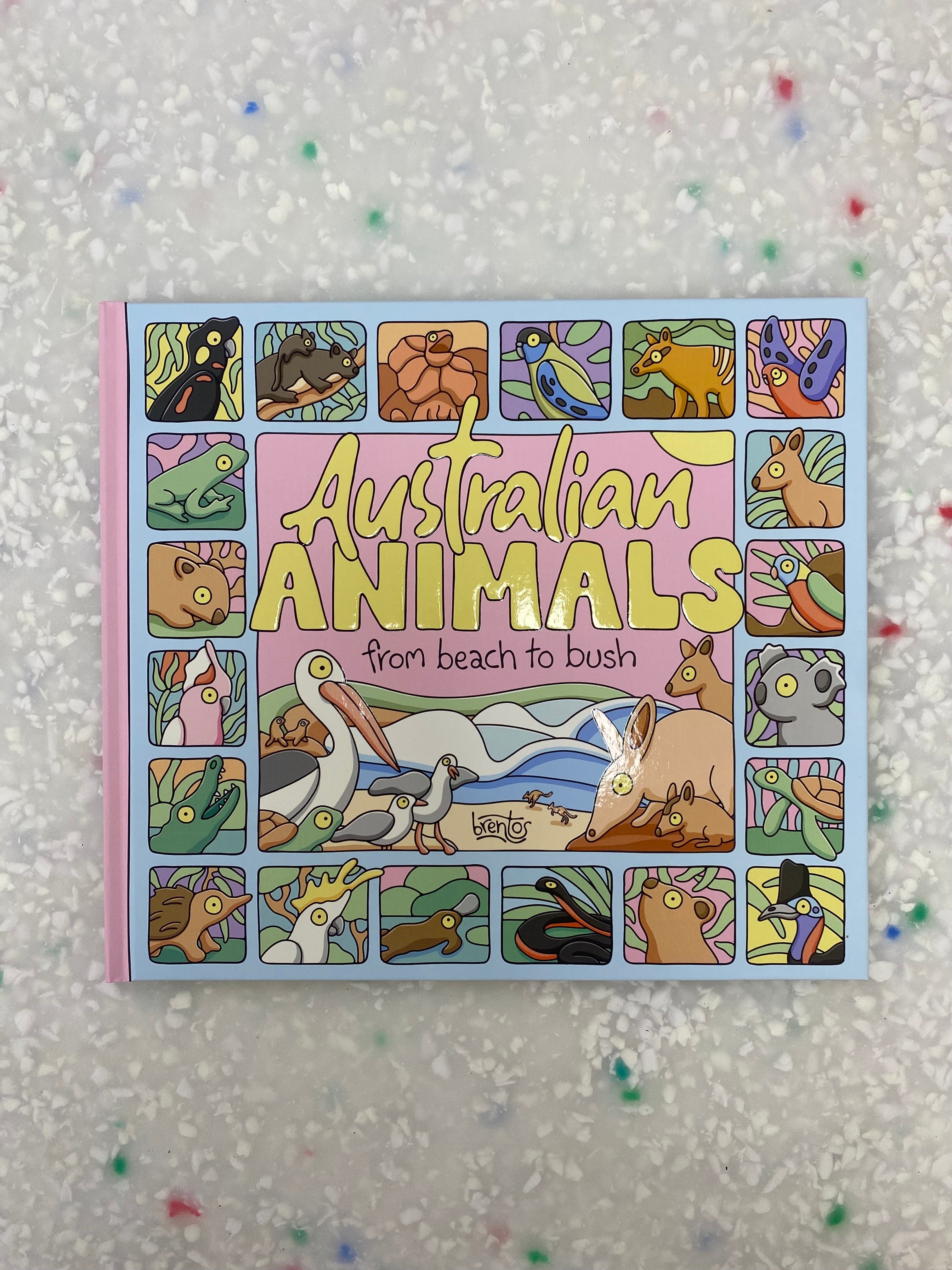 On a speckled background, the BAY KIDS children's book "Australian Animals: From Beach To Bush" features a cover adorned with colorful illustrated native wildlife characters arranged in small squares and rectangles, framing the main title area.