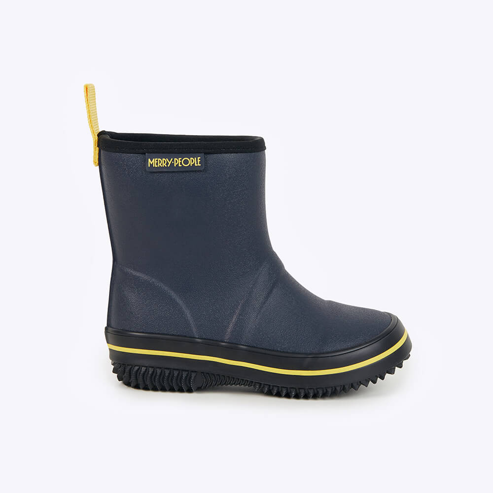 The Merry People Andie Kids Gumboot in Midnight Blue features black trim, yellow accents, a yellow pull tab, and a rugged black sole. Perfect for adventurous kids, it's a vegan-friendly boot with the "Merry People" logo on the side, displayed against a white background.