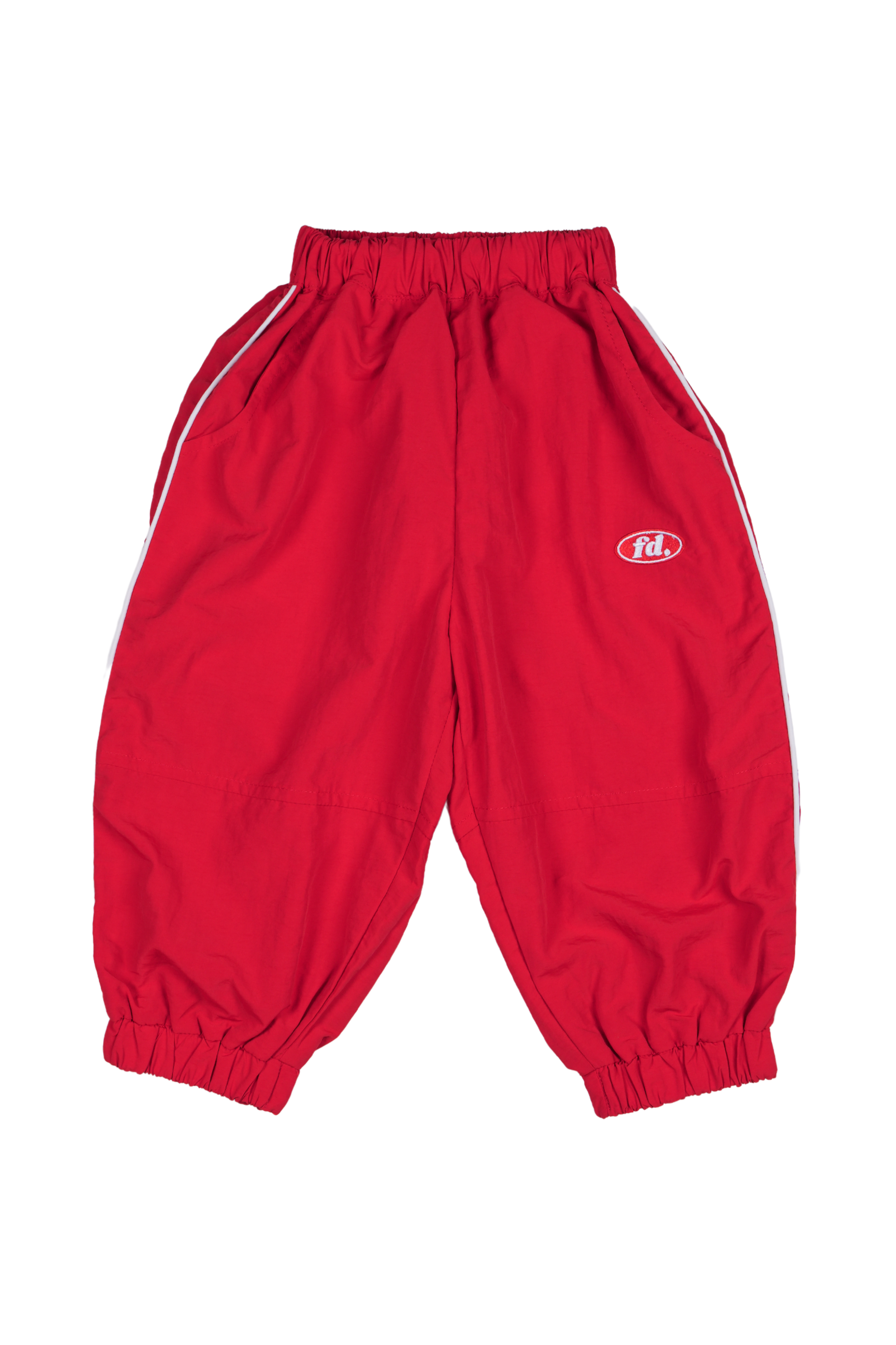 Franco's Dad ~ Sports Star Tracks Red by FRANCO'S DAD are red baggy track pants featuring a comfortable stretch waistband and cuffs, with white side stripes and a small logo on the upper left. The material is lightweight and sporty.