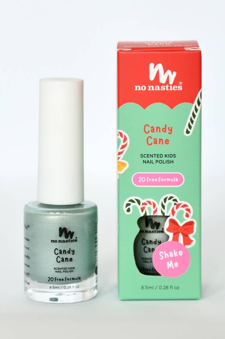 A green bottle of NO NASTIES Candy Cane Water Based Scented Scratch Off Kids Nail Polish is positioned beside its vibrant box adorned with candy cane illustrations. The packaging emphasizes its "20 Free Formula" and "Shake Me" instructions, celebrating its cruelty-free and non-toxic ingredients.