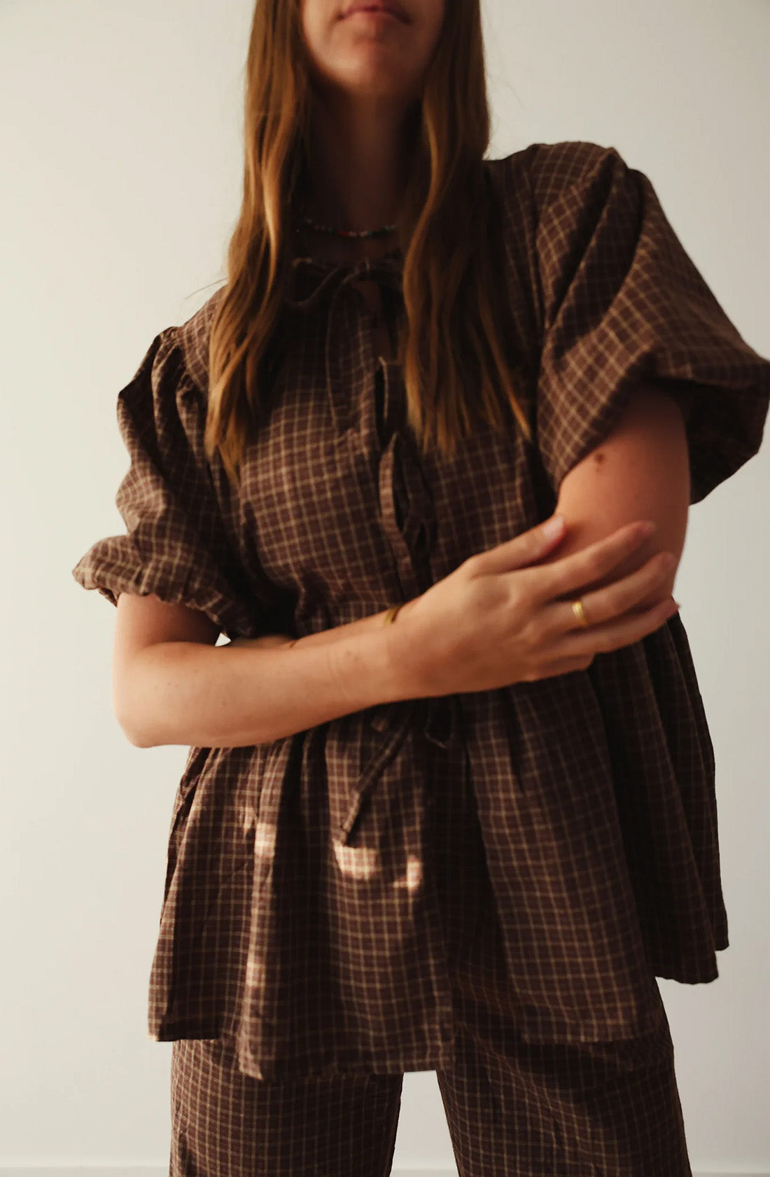 A women wearing the mama cami blouse and matching pant.