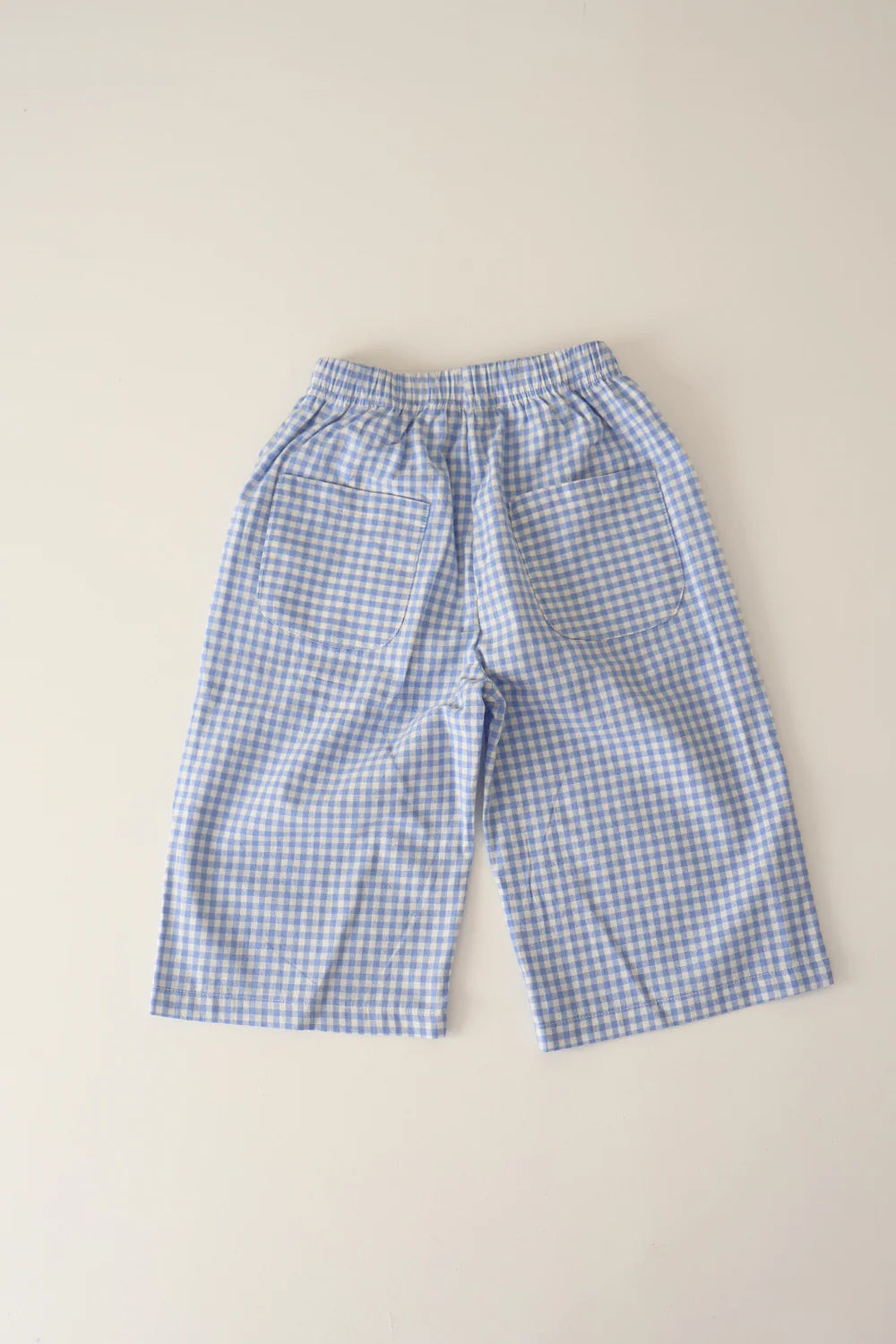 WORN CURATIONS All Day Pant Cornflower: blue and white unisex gingham pants with a comfy elastic waistband, displayed flat on a light surface.