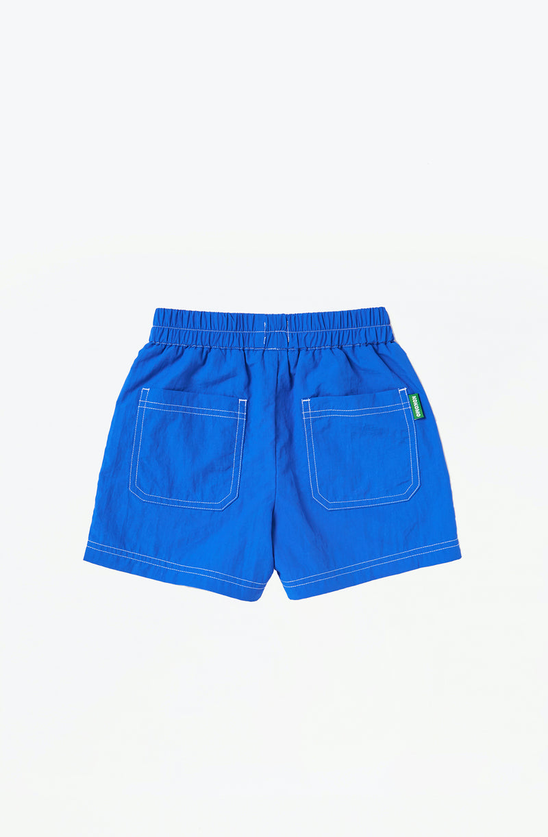 Back of bright blue runner shorts flat laid on white background
