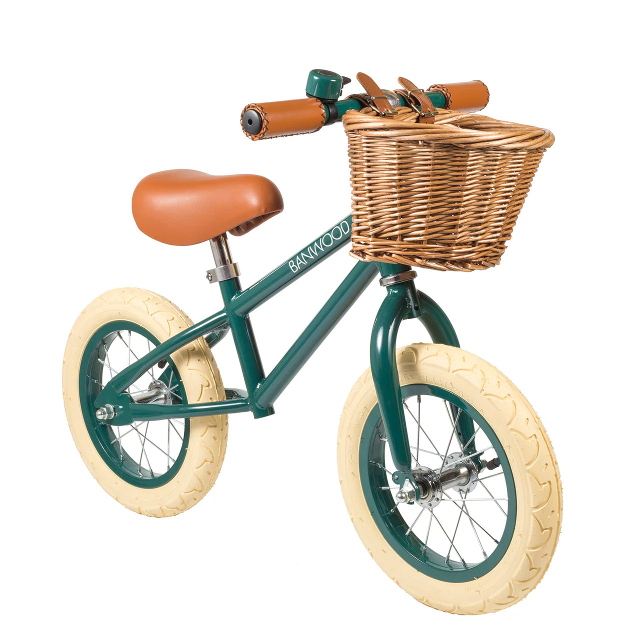 A 45 degree angle shot of a dark green banwood vintage balance bike with a straw basket.