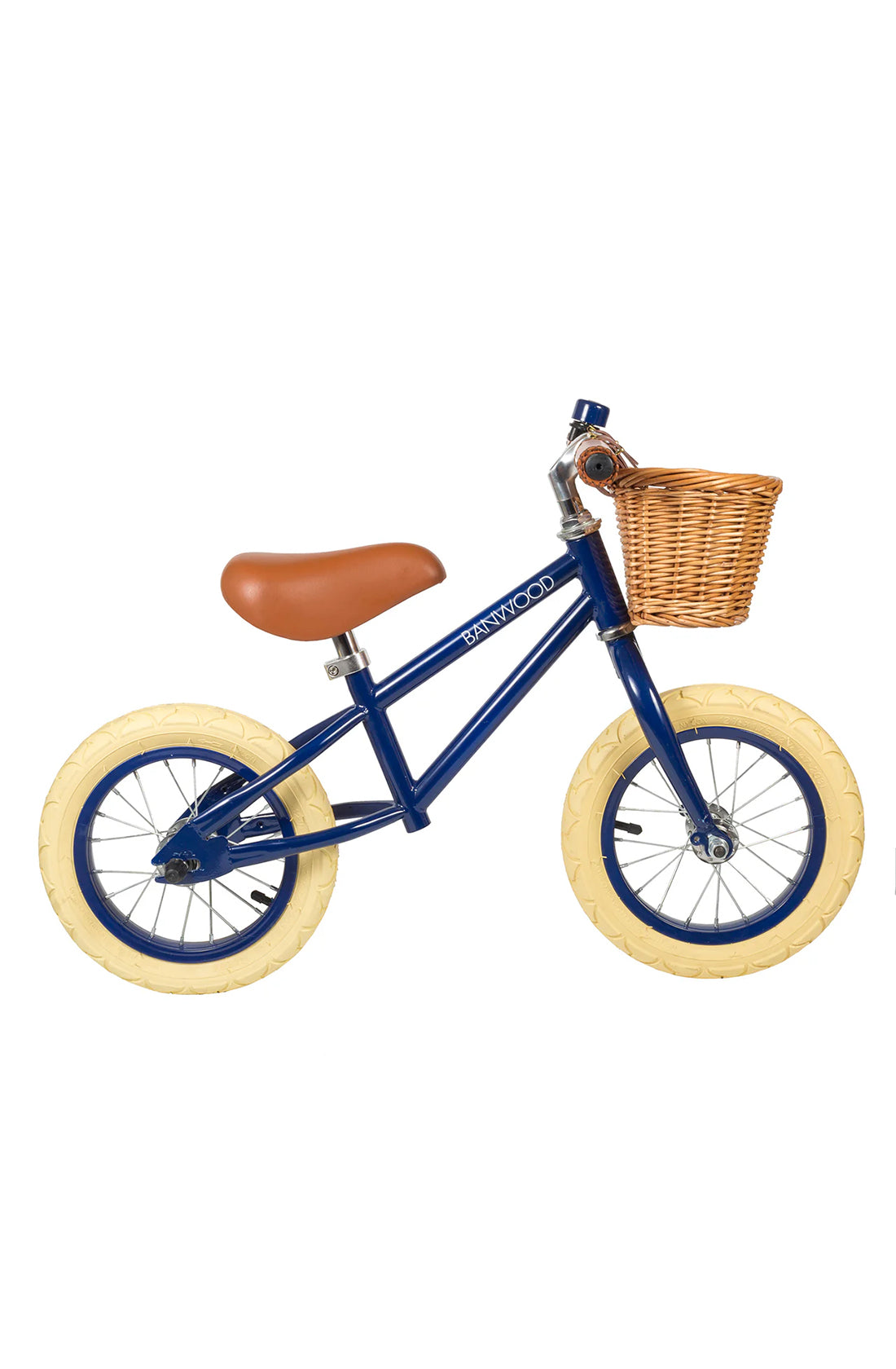 A side on shot of a navy blue banwood vintage balance bike with a straw basket.