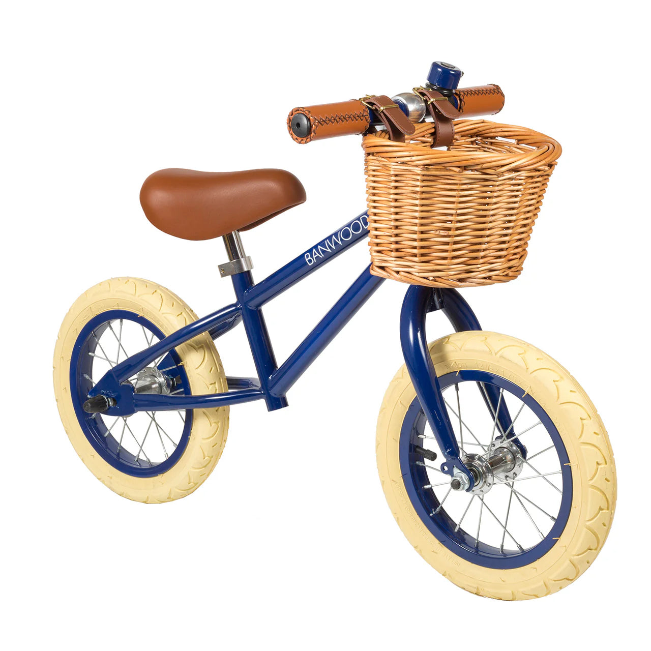 A 45 degree angle shot of a navy blue banwood vintage balance bike with a straw basket.