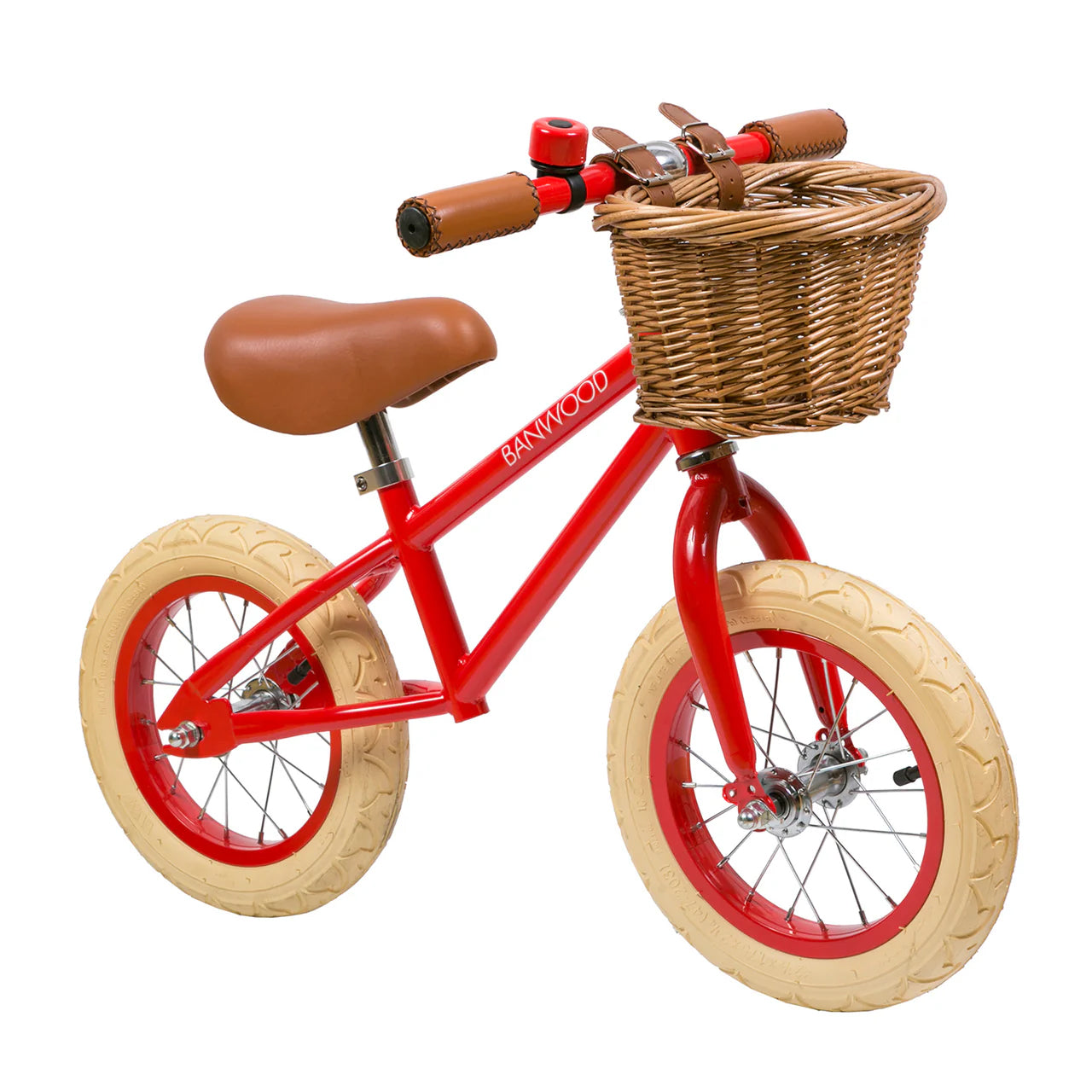 A 45 degree angle shot of a red banwood vintage balance bike with a straw basket.