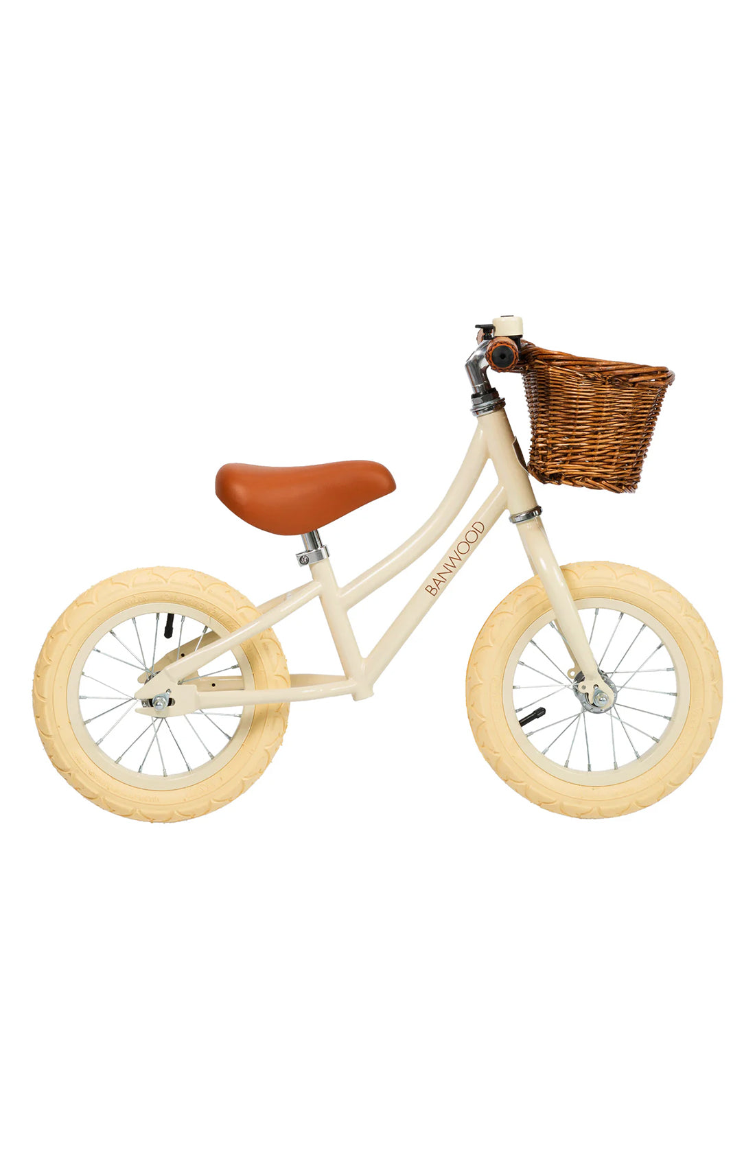 A side on shot of a cream banwood vintage balance bike with a straw basket.