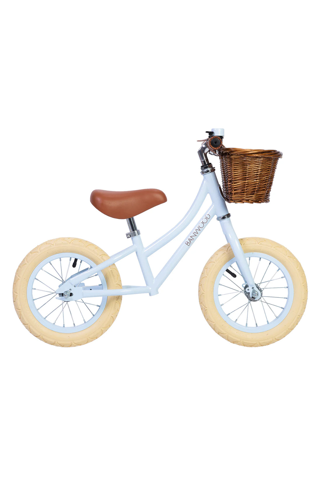 A side on shot of a sky blue banwood vintage balance bike with a straw basket.