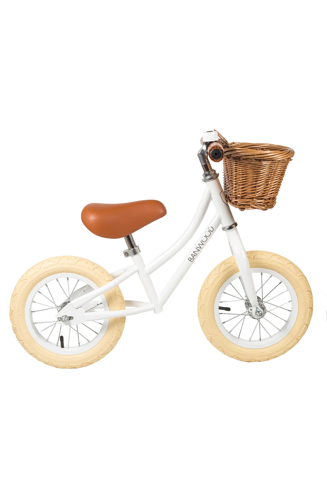 A side on shot of a white banwood vintage balance bike with a straw basket.