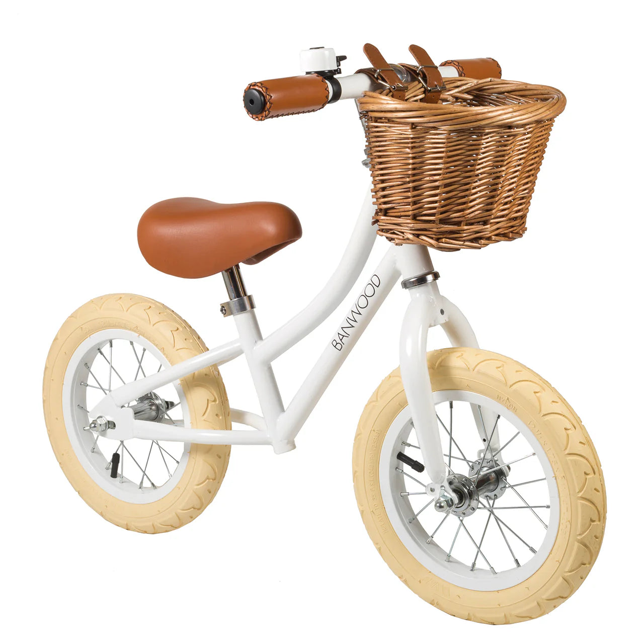 A 45 degree angle shot of a white banwood vintage balance bike with a straw basket.