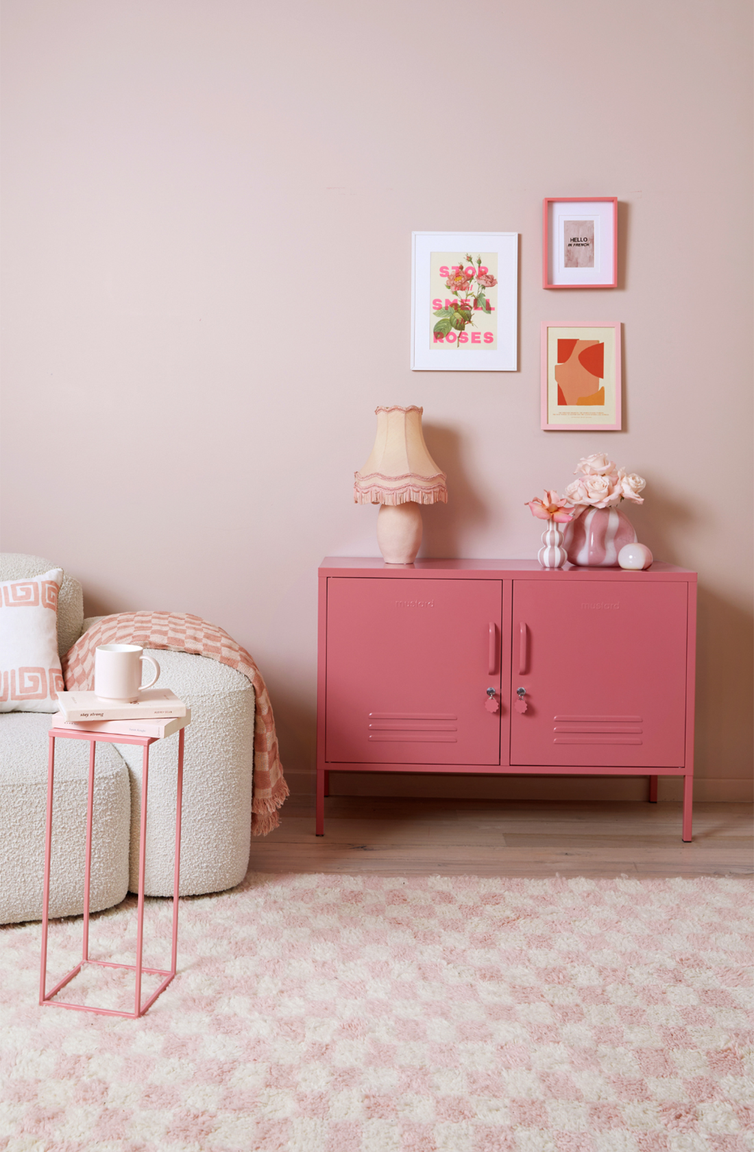 The lowdown locker in berry in a living room next to a chair.