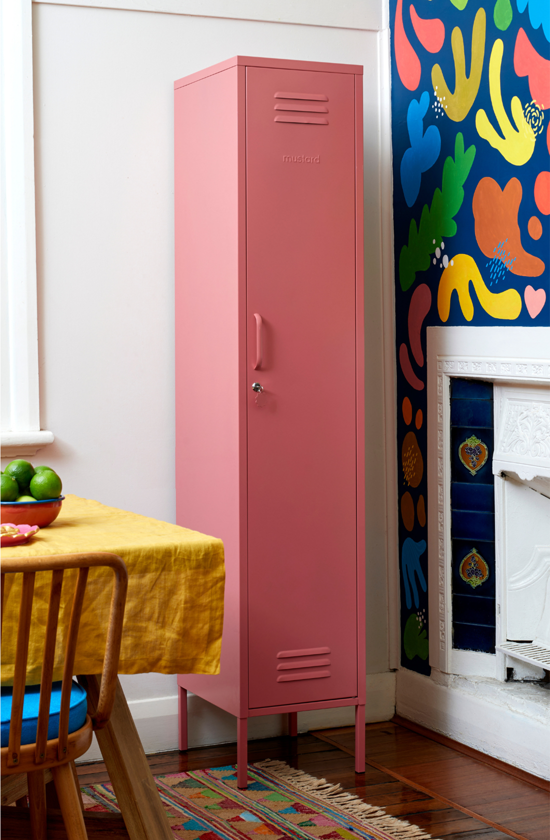 The skinny locker in berry in a dining room next to a table.