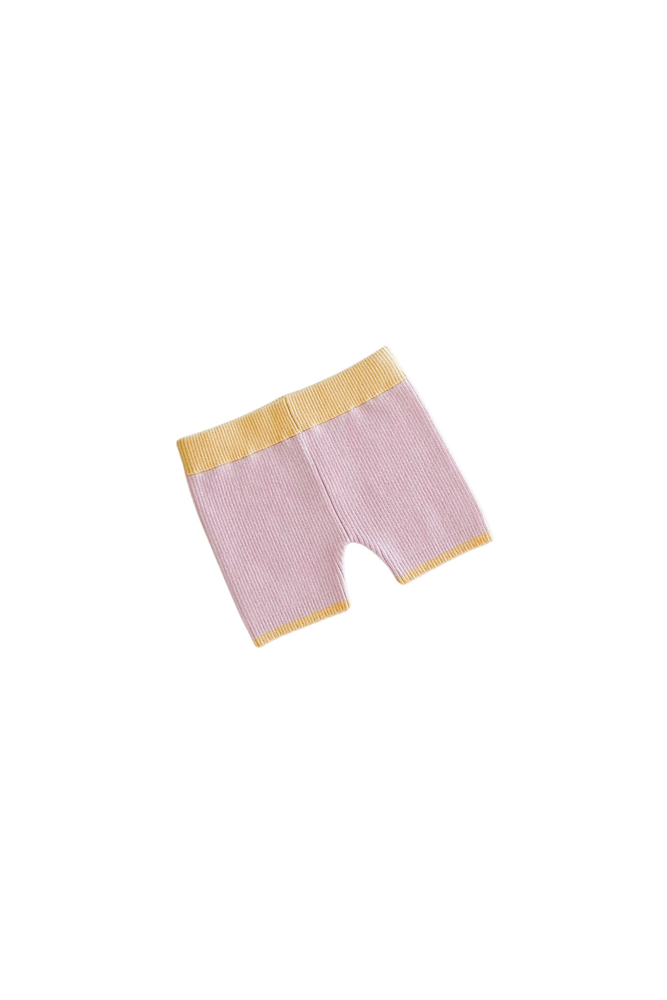 Displayed against a black background are ZIGGY LOU's Bike Shorts Clementine in pink, featuring a yellow elastic waistband and hem. Crafted from a stretch cotton blend, these versatile shorts promise style and comfort for any casual outing.