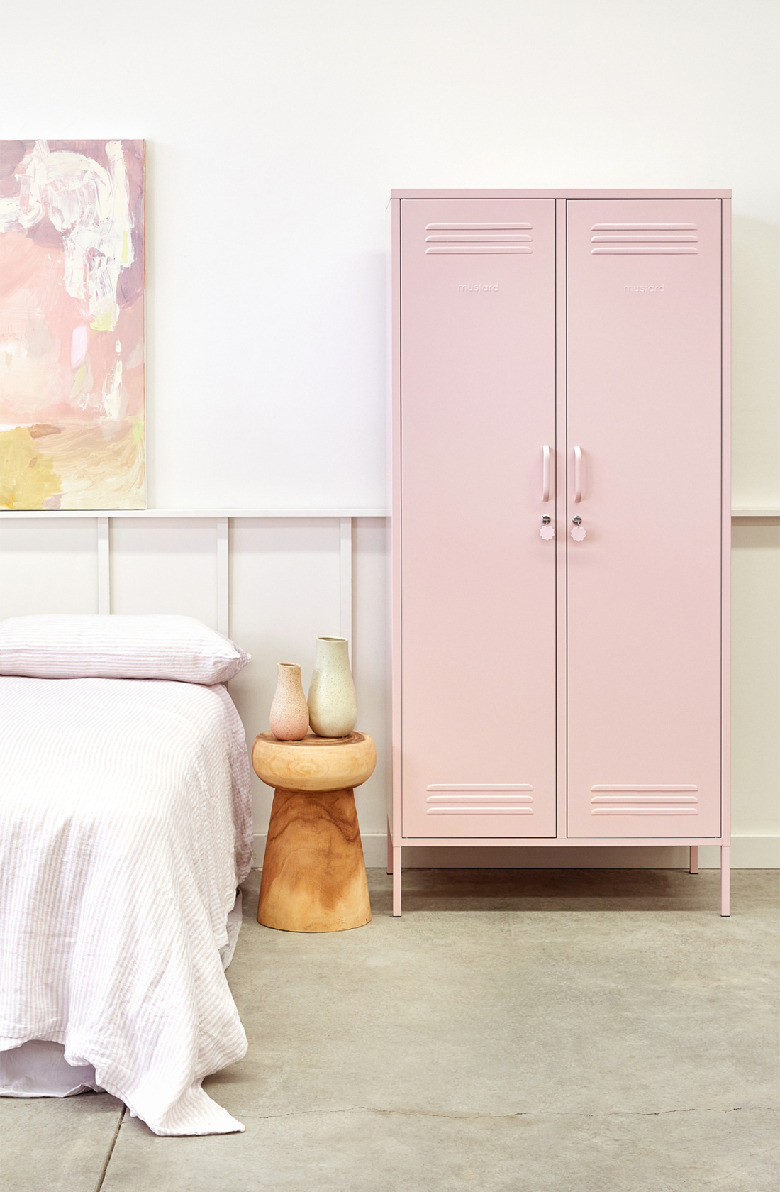 The twinny locker in blush next to a bed.