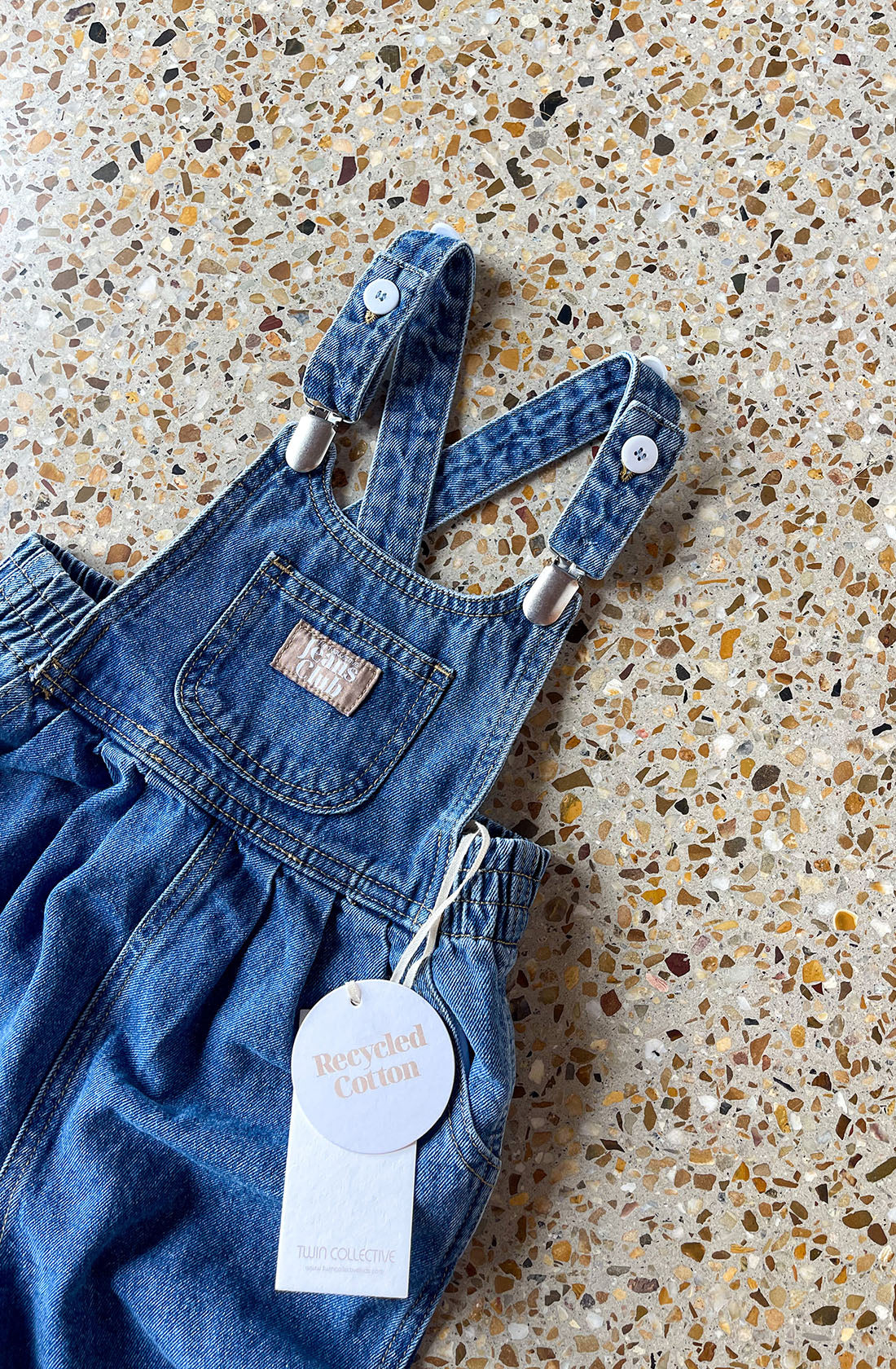 Close up of overall straps on the Bowie denim dress