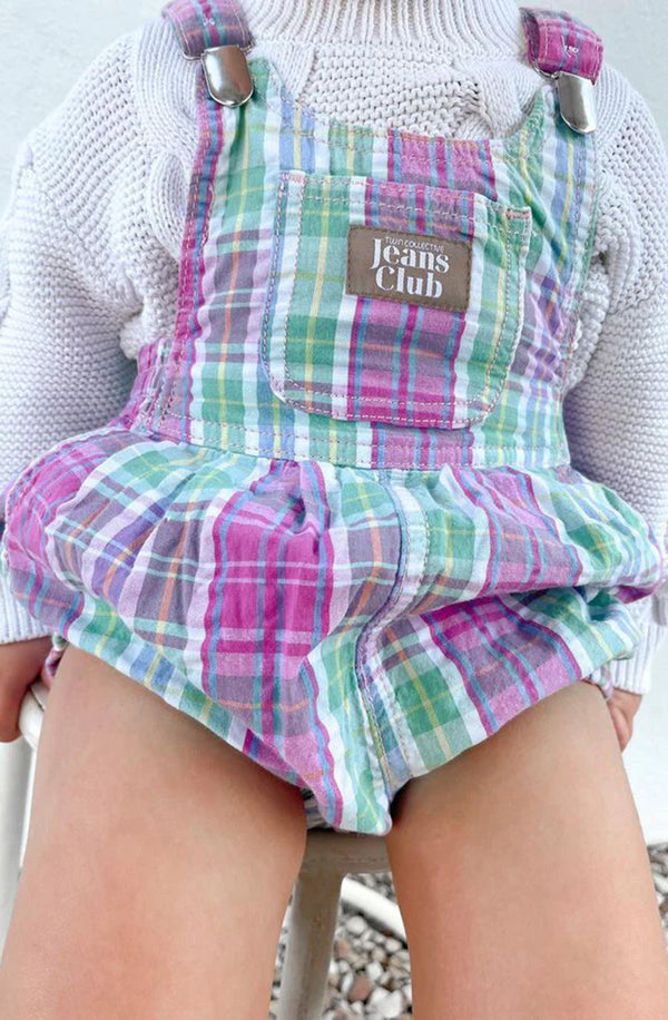 Close up of girl wearing the check romper