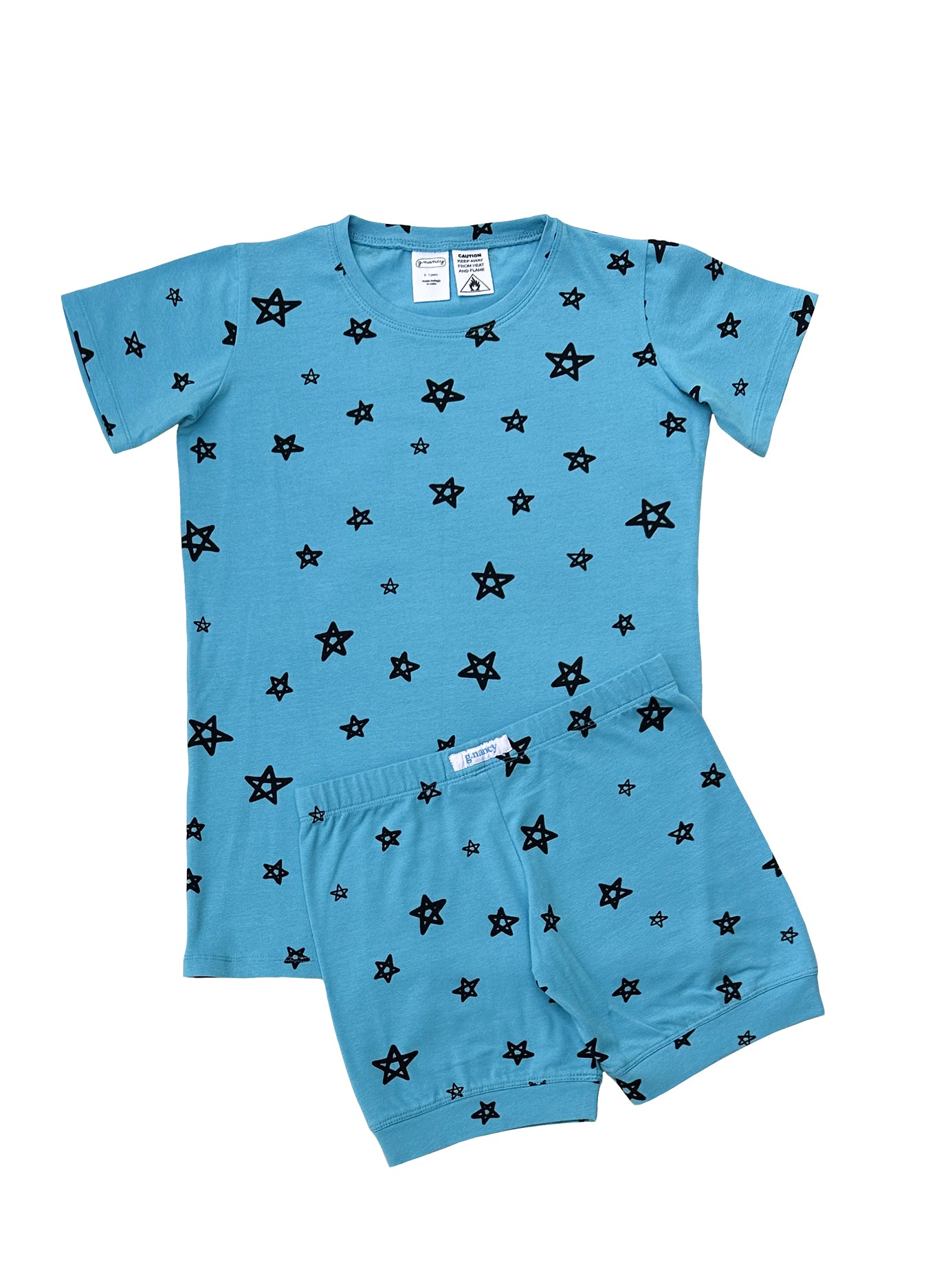 Introducing the Star Shortie PJ Set Breeze from G.NANCY: a blue short-sleeved shirt and shorts ensemble crafted from super soft, organic cotton adorned with a pattern of black stars. Ideal for those in search of GOTS certified sleepwear that seamlessly blends comfort with style.