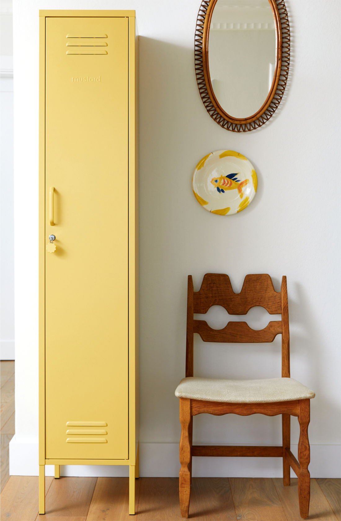 The skinny locker in butter next to a chair.