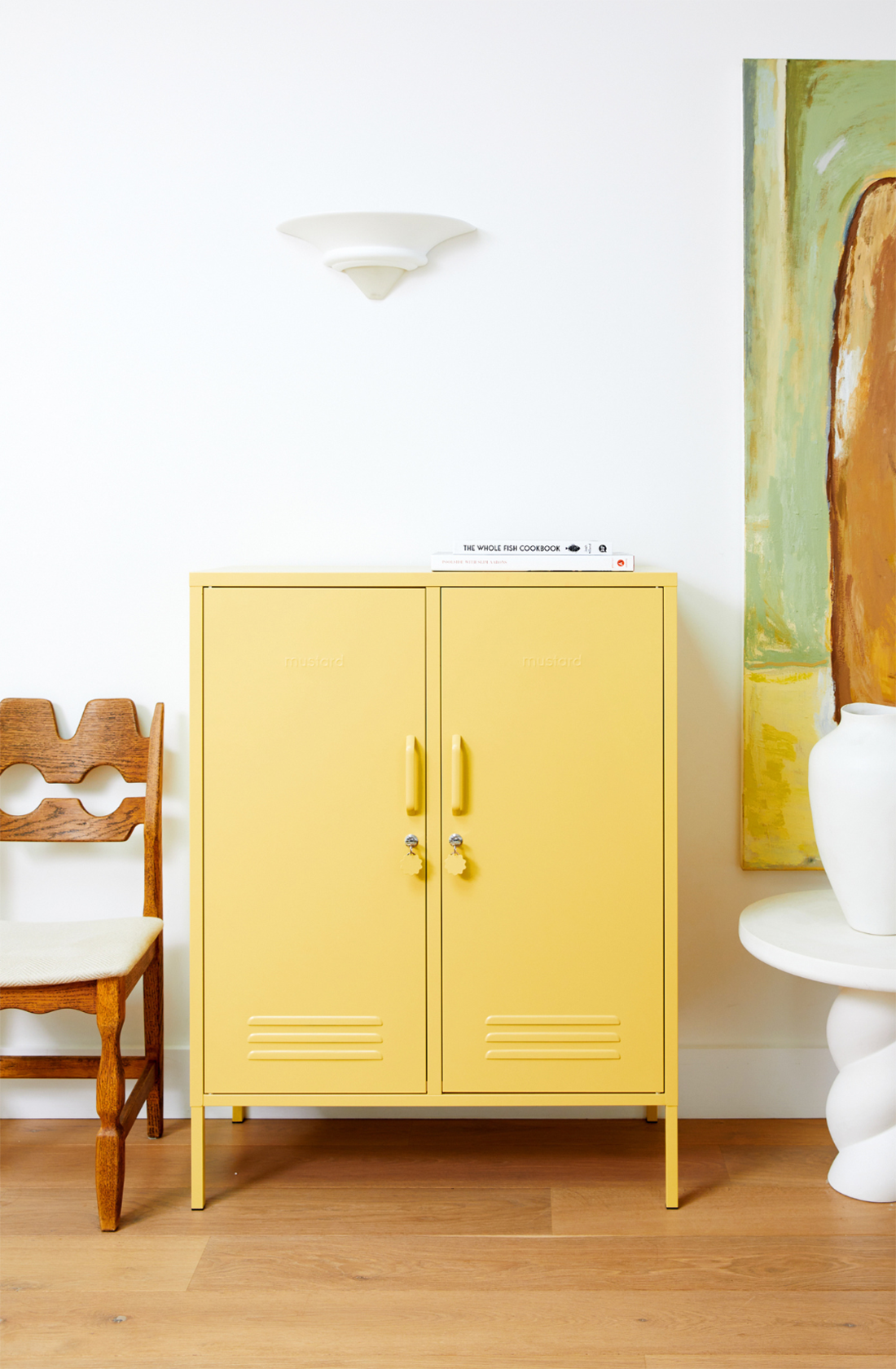 The midi locker in butter next to chair.