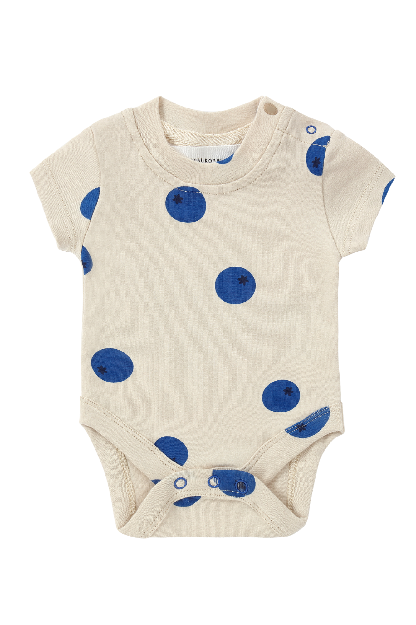 The SUSUKOSHI Classic Bodysuit Blueberries is a cream-colored baby onesie crafted from organic cotton and designed in Australia. It features short sleeves with large blue polka dots and includes snap closures at the bottom and one shoulder for easy dressing, ensuring it is ethically made.