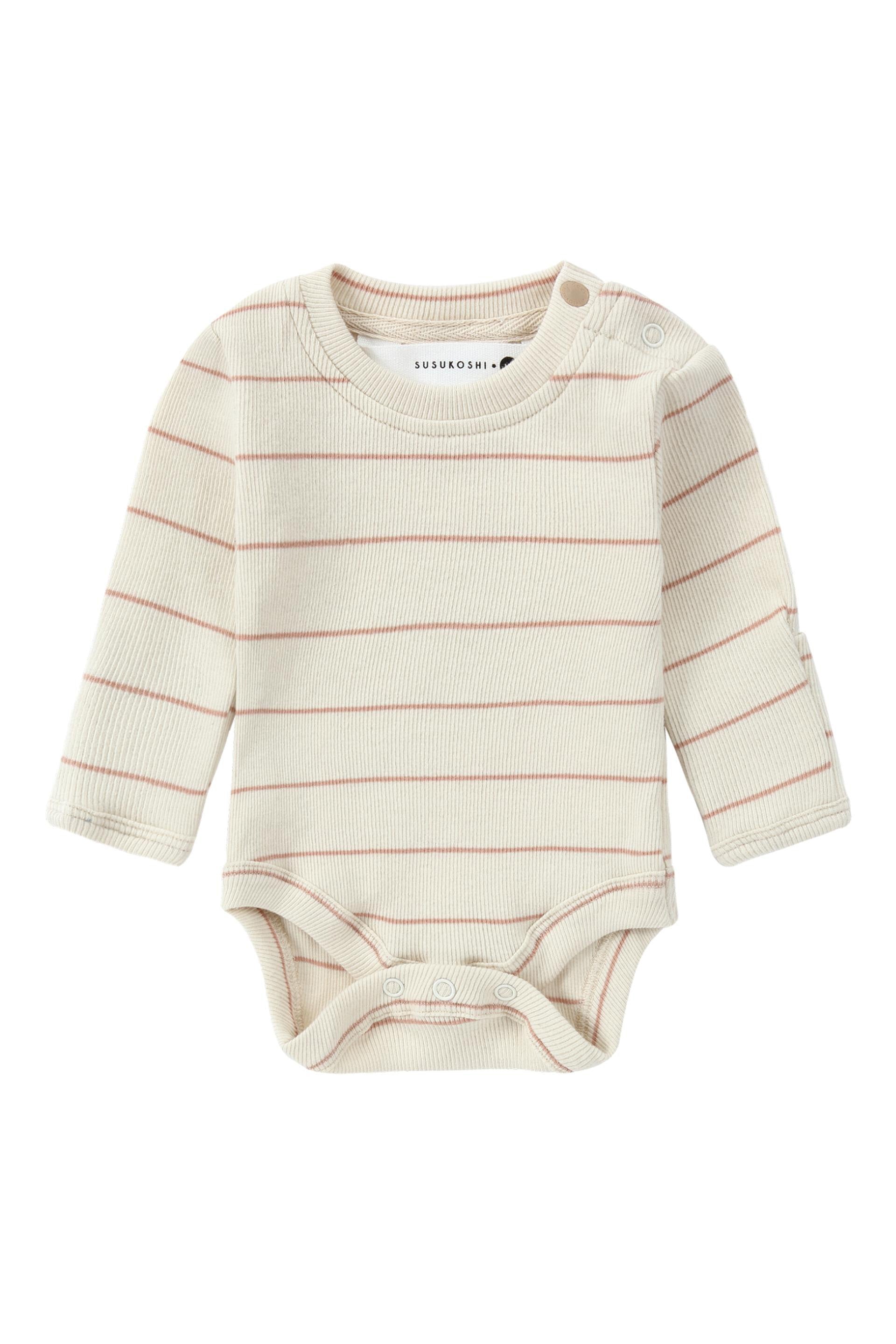 A cream-colored long-sleeve baby onesie with thin horizontal red stripes, ethically made in China. The Classic Bodysuit Coco Stripe from SUSUKOSHI is crafted from organic cotton and features a round neckline, a snap button closure on one shoulder, and three snap buttons at the bottom for easy diaper changes. The brand label "SUSUKOSHI" is visible on the collar.