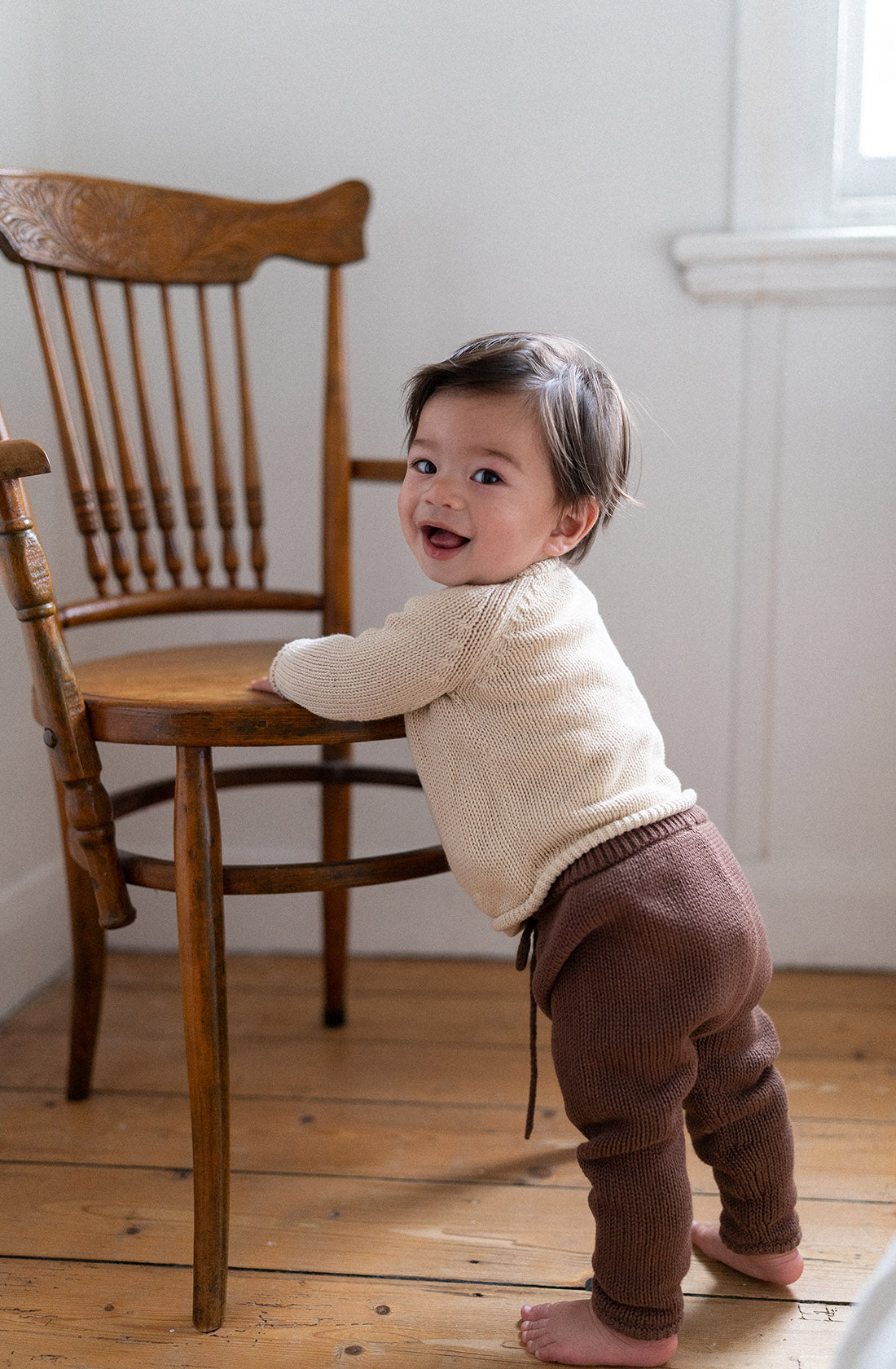 Young toddler in the poet knit pants in cocoa.