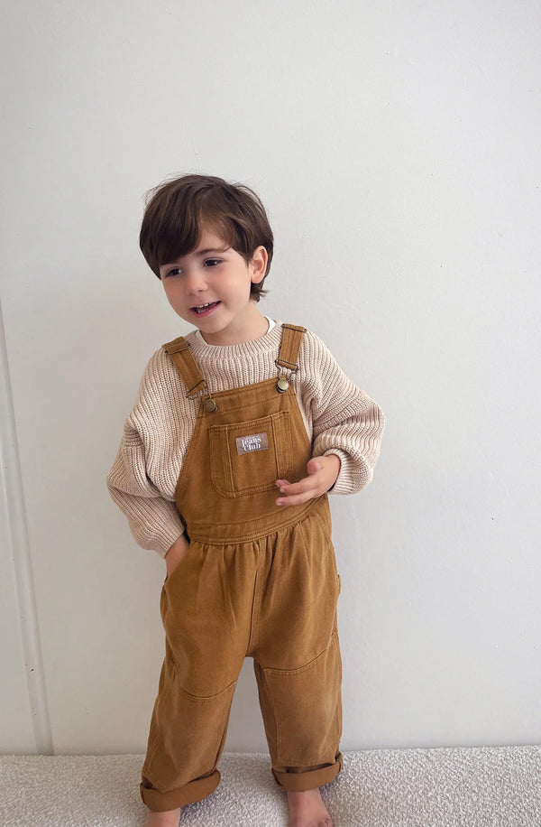 Boy wearing the Carpenter overalls with knit underneath