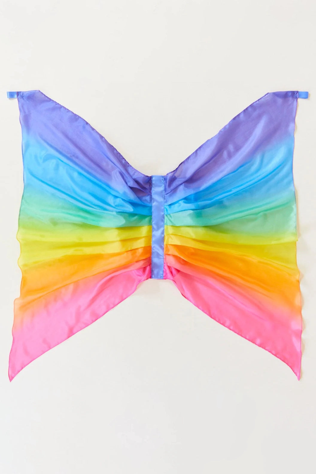 Introducing the Rainbow Wings by SARAH'S SILKS, these butterfly wings are perfect for dress-up. The design features vibrant shades of purple, blue, green, yellow, orange, and pink set against a neutral background, with the silky fabric beautifully gathered at the center.