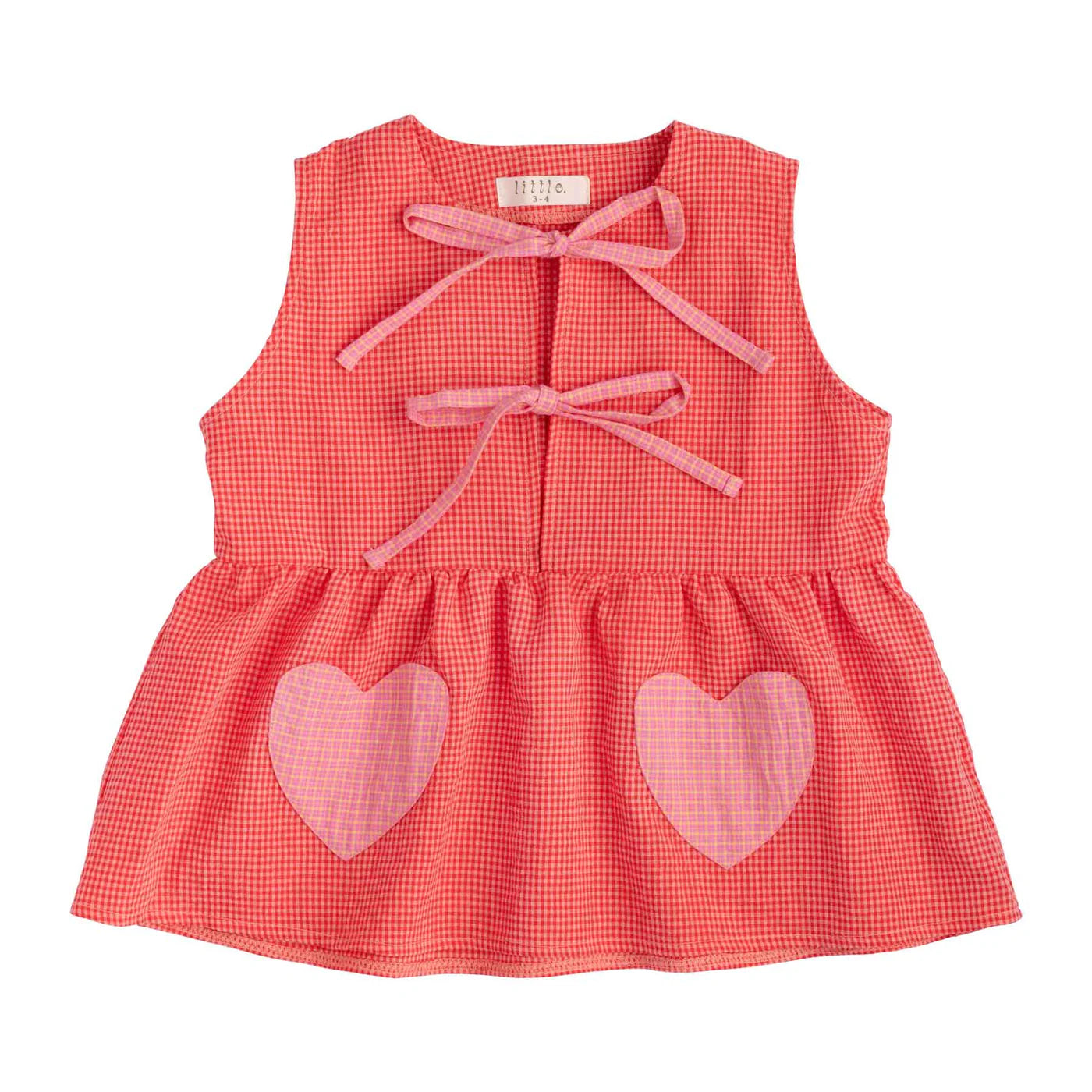 The Polly Pocket Blouse Cherry Gingham by LITTLE THE LABEL is a sleeveless seersucker cotton top featuring two front bows and heart-shaped pockets at the bottom.