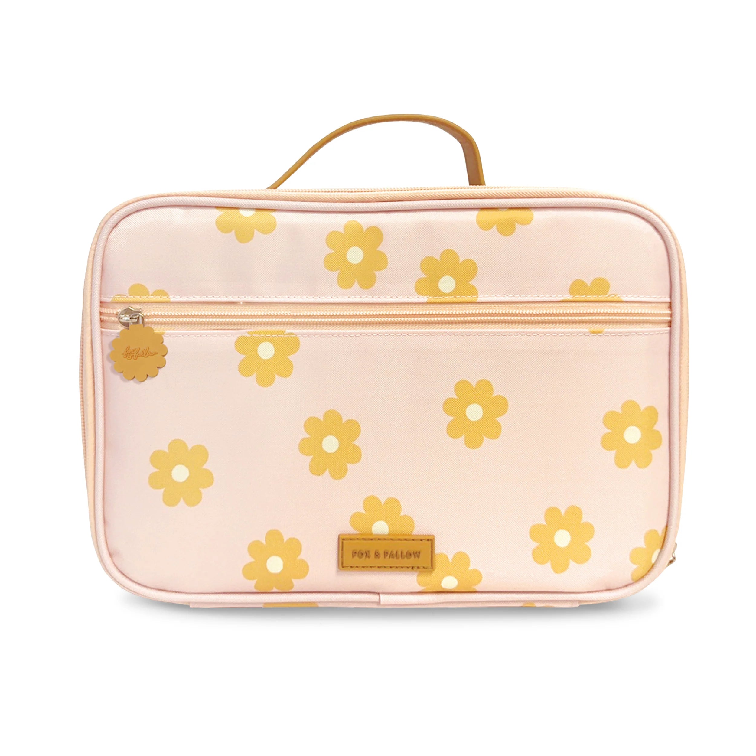 The Daisy Chain Lunch Bag by FOX & FALLOW is a light pink rectangular bag adorned with yellow flower prints. It features a horizontal zippered pocket on the front and a tan handle on the top. A small brown label with engraved text is located on the front bottom edge, similar in design to some stylish lunch bags.