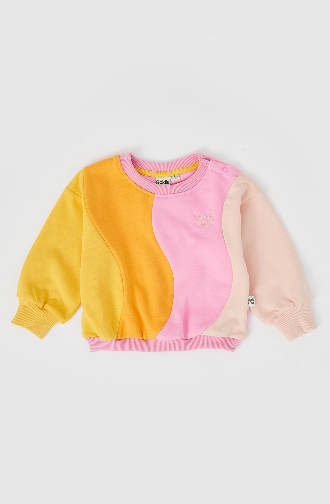 The rio wave sweater in pink/gold.