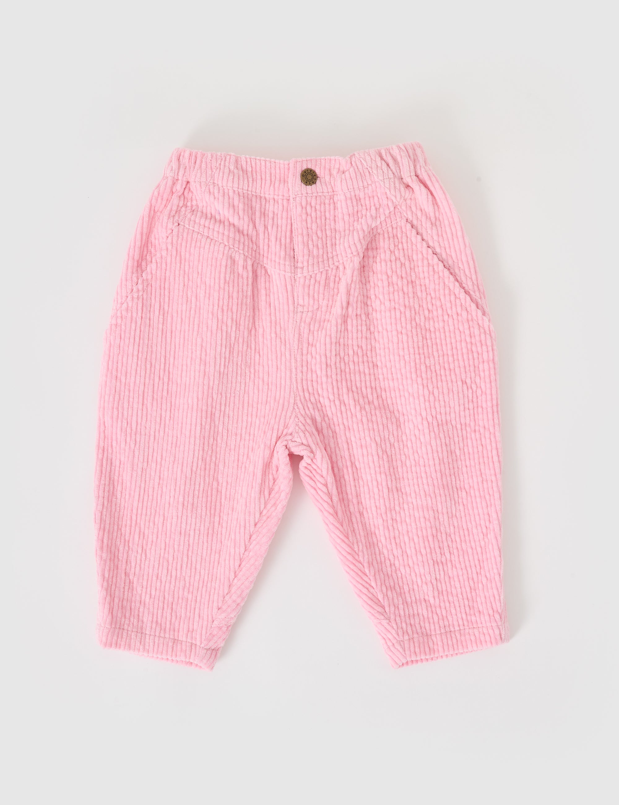 These pink GOLDIE + ACE Nora toddler corduroy pants feature a retro style, textured pattern, elastic waistband, and front button. With a mid-rise design and two side pockets, they're shown on a white background.