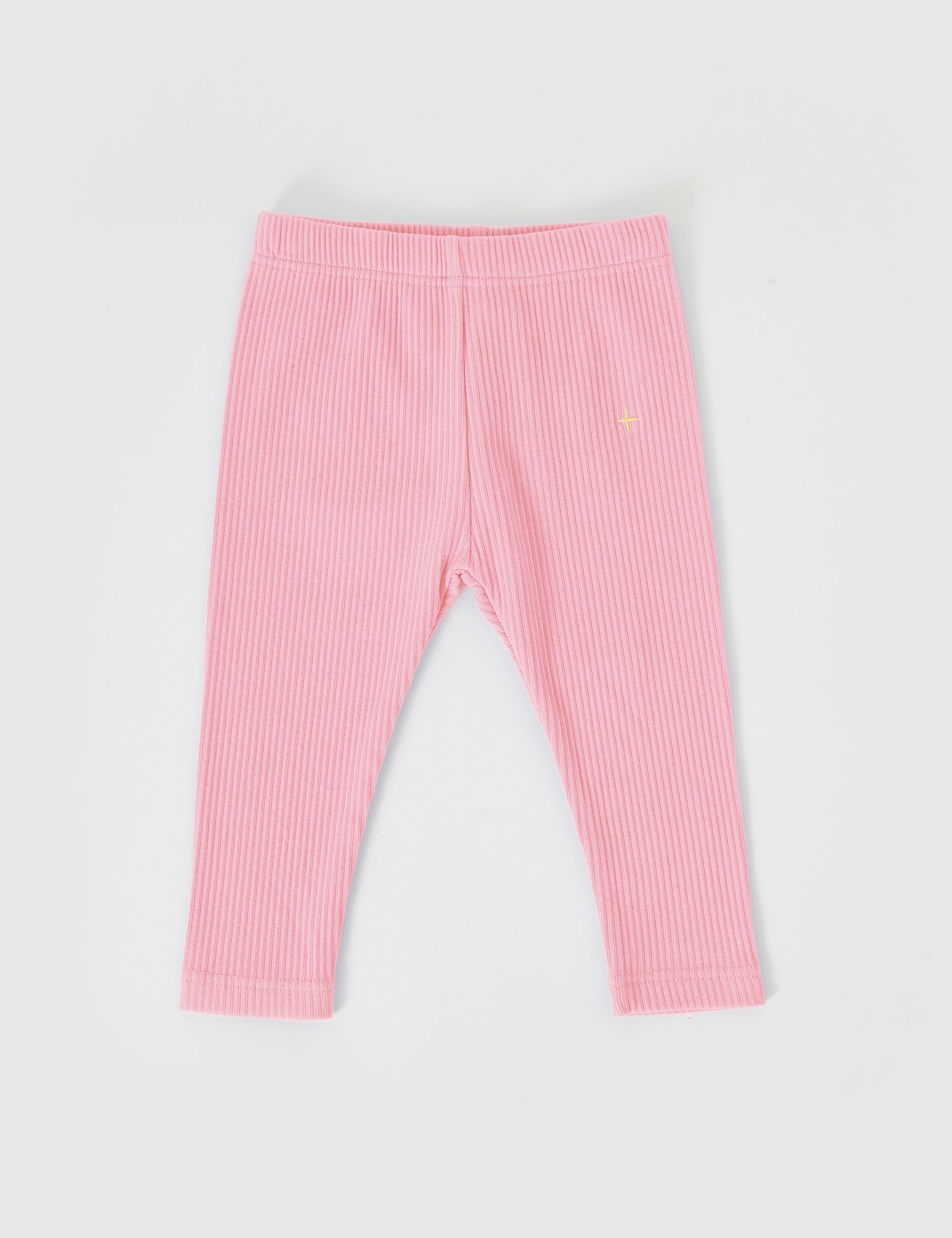 The Goldie + Ace ~ Bowie Rib Legging Sweet Pea by GOLDIE + ACE are pink ribbed baby leggings with a small embroidered star on the left, featuring a comfortable elasticated waistband. Made from cotton/elastane for good stretch, they are displayed on a plain white background.