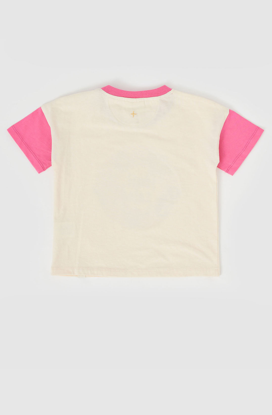 A back view of the short-sleeve Fruit Salad Friends T-shirt by GOLDIE + ACE. The main body is white, while the sleeves are bright pink. The neckline features a combination of white and pink trim. Made from super soft stretch cotton jersey, the fabric looks incredibly comfortable.