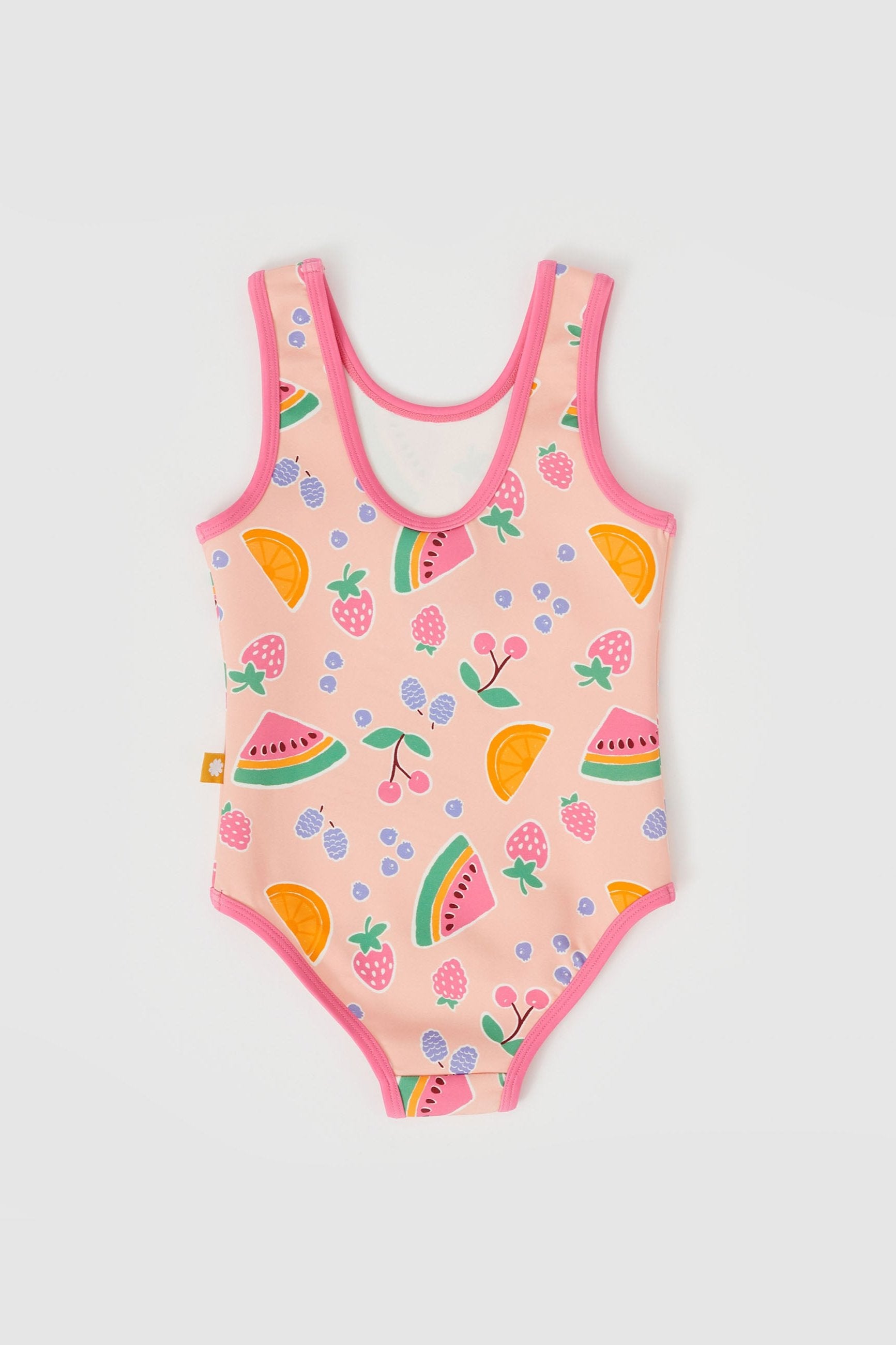 The Fruit Salad Scoop Back Bathers by GOLDIE + ACE is a pink, sleeveless one-piece swimsuit with a scoop neck. It features hand-drawn graphics of colorful fruits such as watermelon slices, strawberries, cherries, blueberries, and orange slices. Made from a Nylon/Spandex blend and trimmed with pink around the edges, this swimsuit fits true to size.