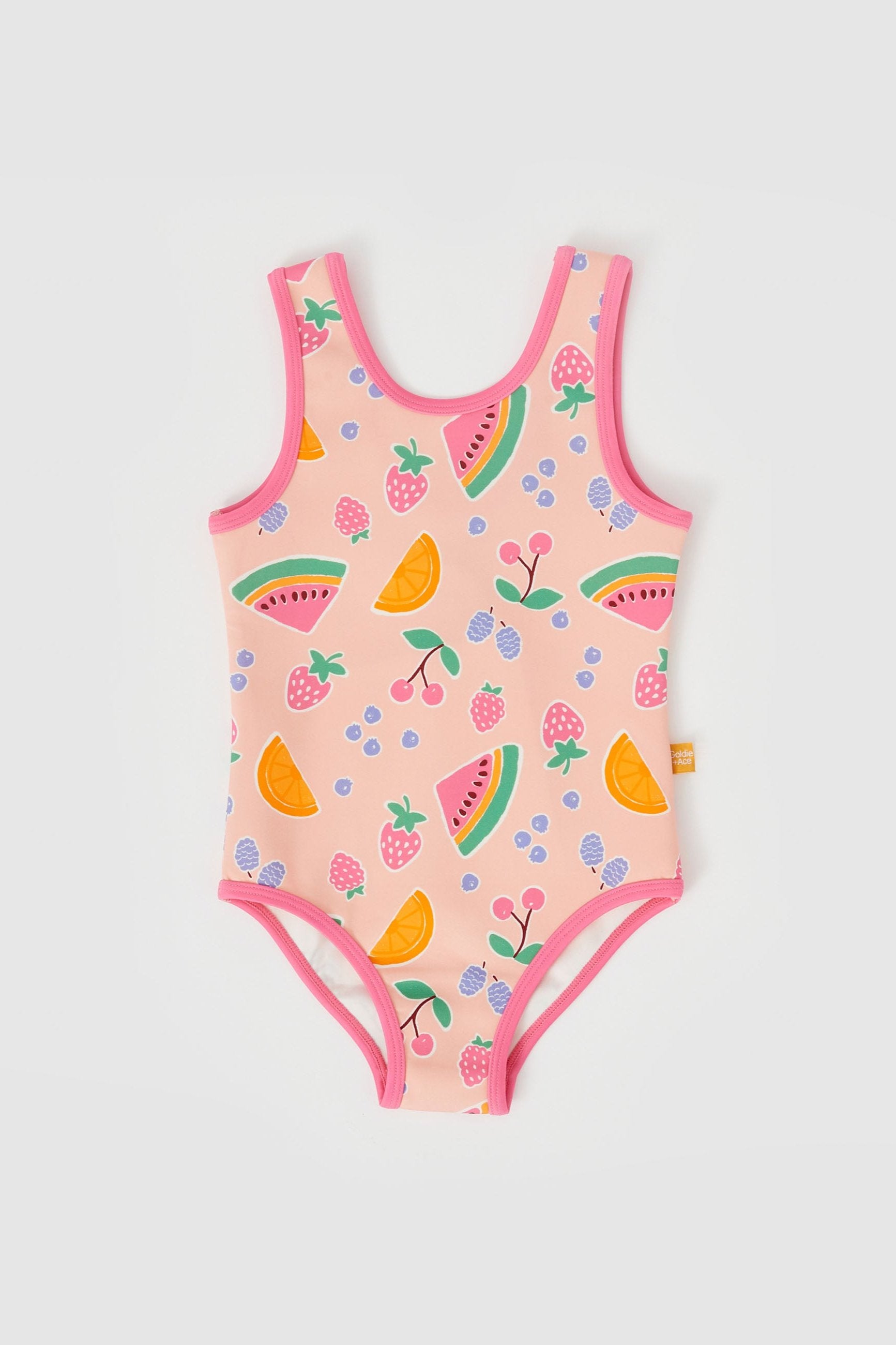 Introducing the Fruit Salad Scoop Back Bathers by GOLDIE + ACE: A true-to-size, sleeveless toddler swimsuit in a vibrant pink. This adorable piece features a scoop neck and is accented with delicate pink piping. It showcases hand-drawn graphics of colorful fruits, including watermelons, oranges, cherries, strawberries, and blueberries. Made from a comfortable Nylon/Spandex blend for easy movement.